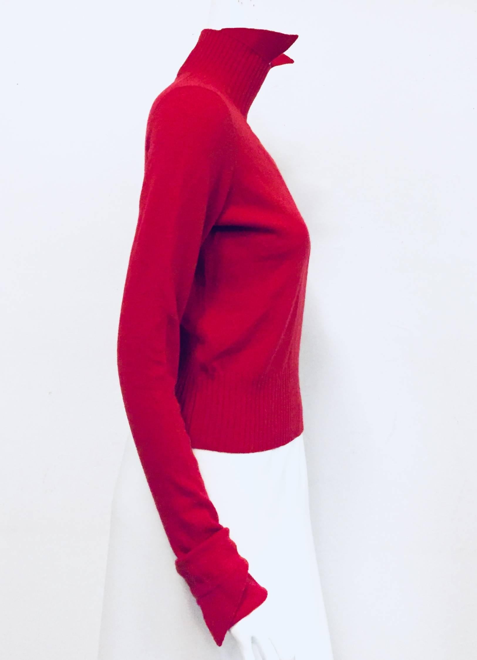 Chanel red cashmere sweater feels amazing and luxurious when worn. It is the kind of piece that will never go out of style. Made of the finest cashmere in the world.  The pointed up collar adds a French flair to this look. This pullover is unlined