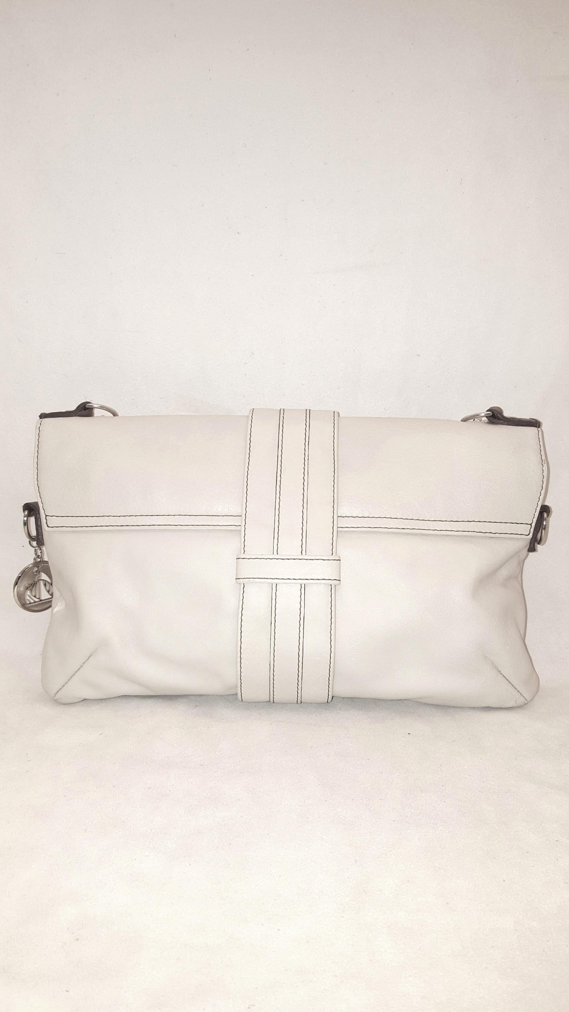 Lanvin ivory leather Hero bag with rolled brown top handle is decorated with three wrap straps around middle of bag.   This bag contains a single flap and push lock closure in gold tone.  Bag is lined in Lanvin logo ivory jacquard with single