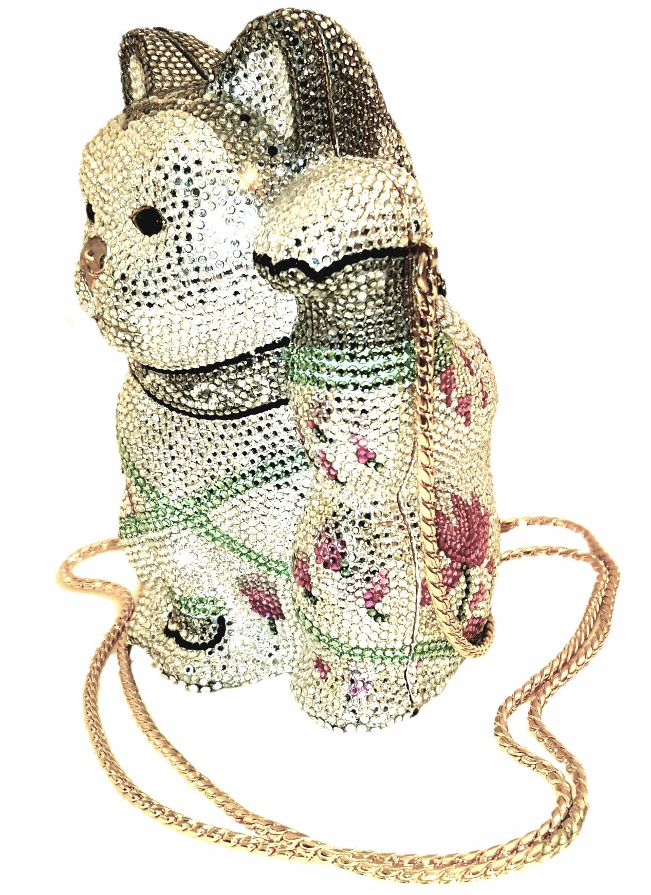 This Judith Leiber clutch replicates the traditional Japanese figurine thought to bring good luck to whomever owns it.  A collector's edition, this minaudière has been crafted in Italy with Austrian clear (silver) crystals creating a glistening