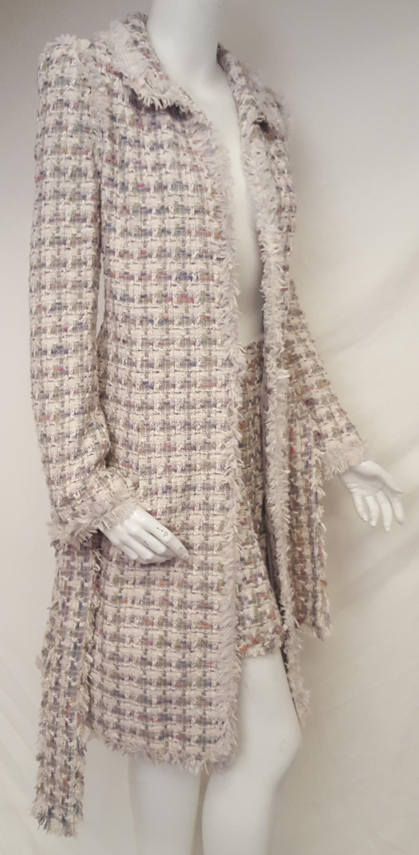 This Chanel multi color signature tweed from the house of Lesage with the fantasy fringe all around was created for the 2004 Spring Collection.  “A” line coat with notch collar with frayed fringe descending down the front of coat and continuing on 