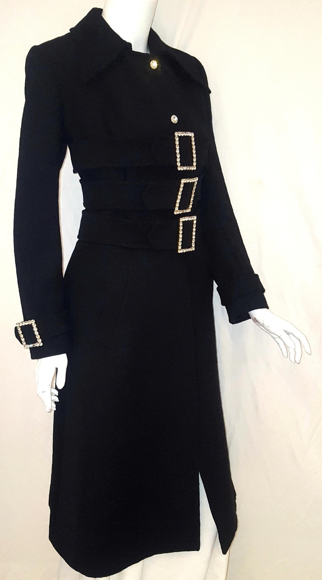 Dolce & Gabbana's 2001 runway black wool coat will be your go to coat for all those fabulous evening events that  you will be attending this fall and winter season.  This spectacular coat has 3 belts and buckles starting at the waist and up to the