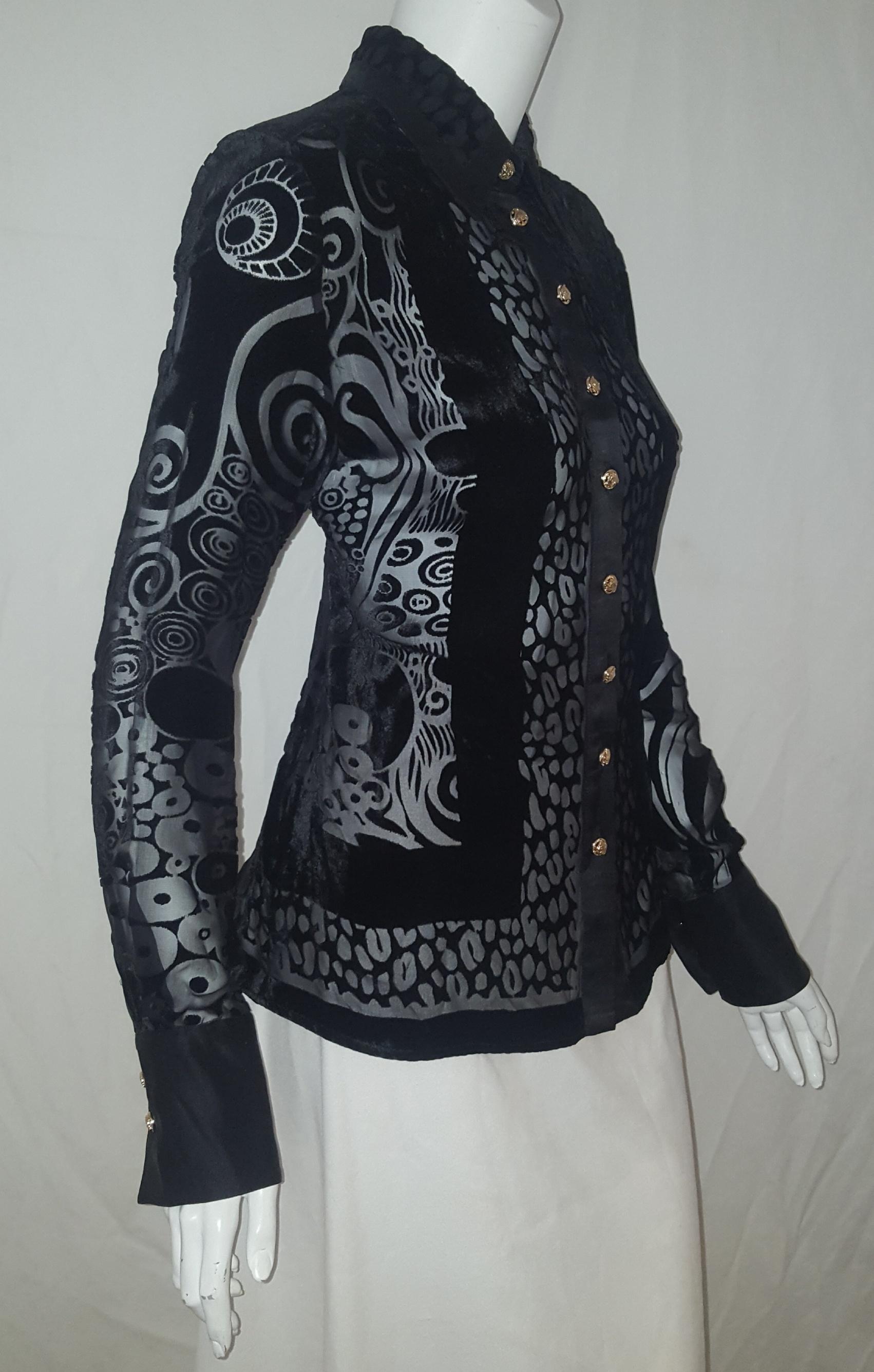 Versace black silk blend with cut velvet arabesque design throughout with long sleeves is pure Versace.  The shirt collar is trimmed in black silk and lined at the back of the collar, also, in black silk.  The top switches from see through to solid