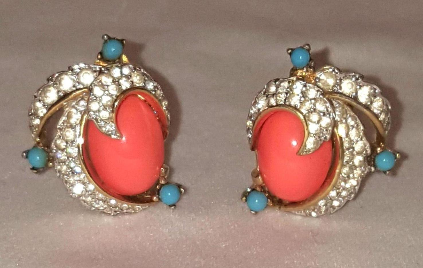 Jomaz has long been recognized as a fantastic maker of unusual jewelry.  This set consisting of a brooch and clip on earrings are colorful and lively!  Brooch sports oval resin coral topped by a cluster of prong set turquoise stones.  Two rows of