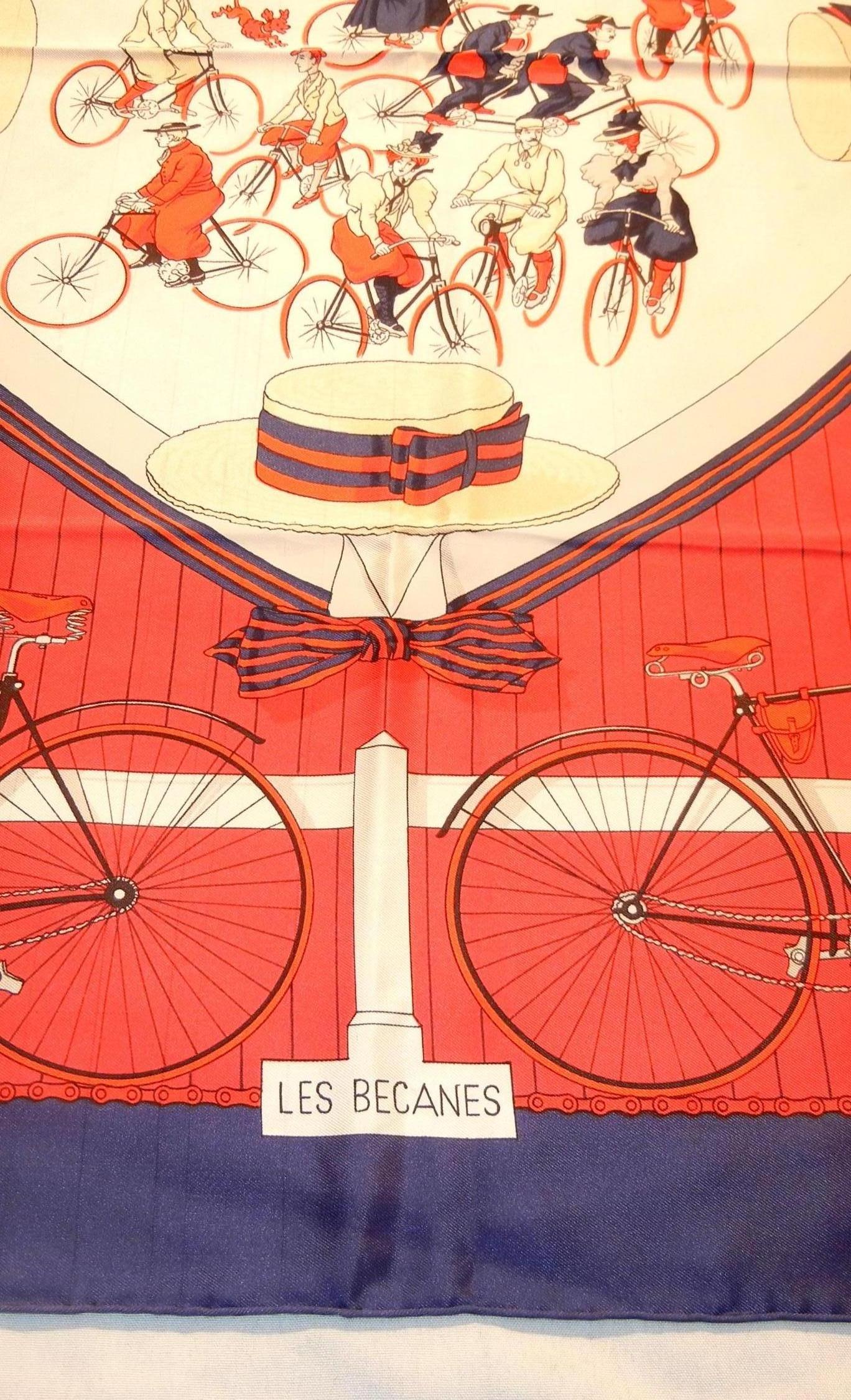 Hermes Les Becanes, the bicyclists, in red, white and blue features a bicycle scene from the early 1900’s.  Hugo Grygkar created  Les Becanes in 1954 and Hermes re-issued it  in 1973.  Scarf design is ornate with a wide blue outer border with hand