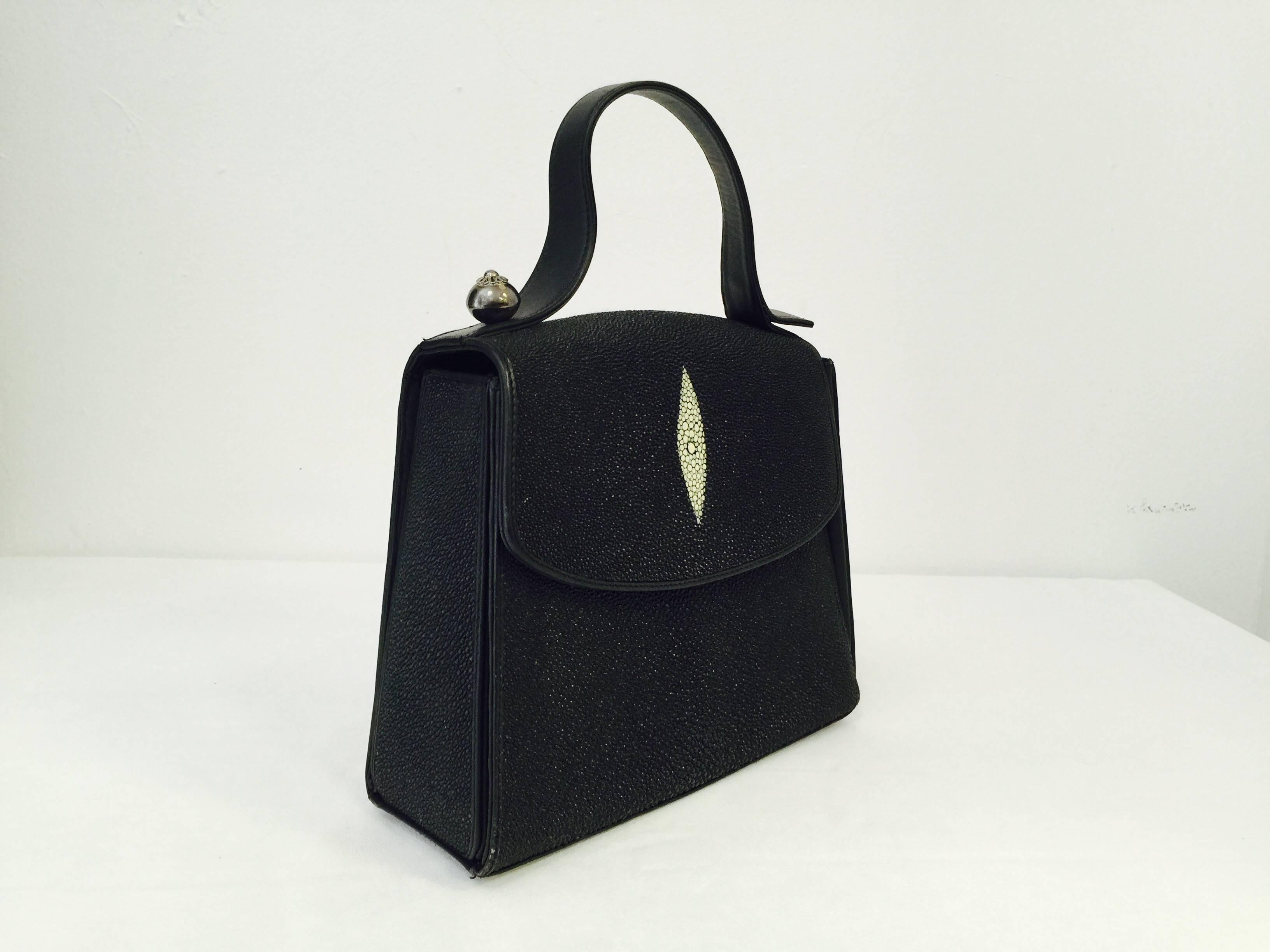New Pako Mikel Stingray Handbag is a welcome addition to any collection!  Crafted from the most exquisite materials, bag is gusseted with smooth leather  and is lined in fine material.  Silver tone hardware.  Flap with magnetic snap closure.  Three