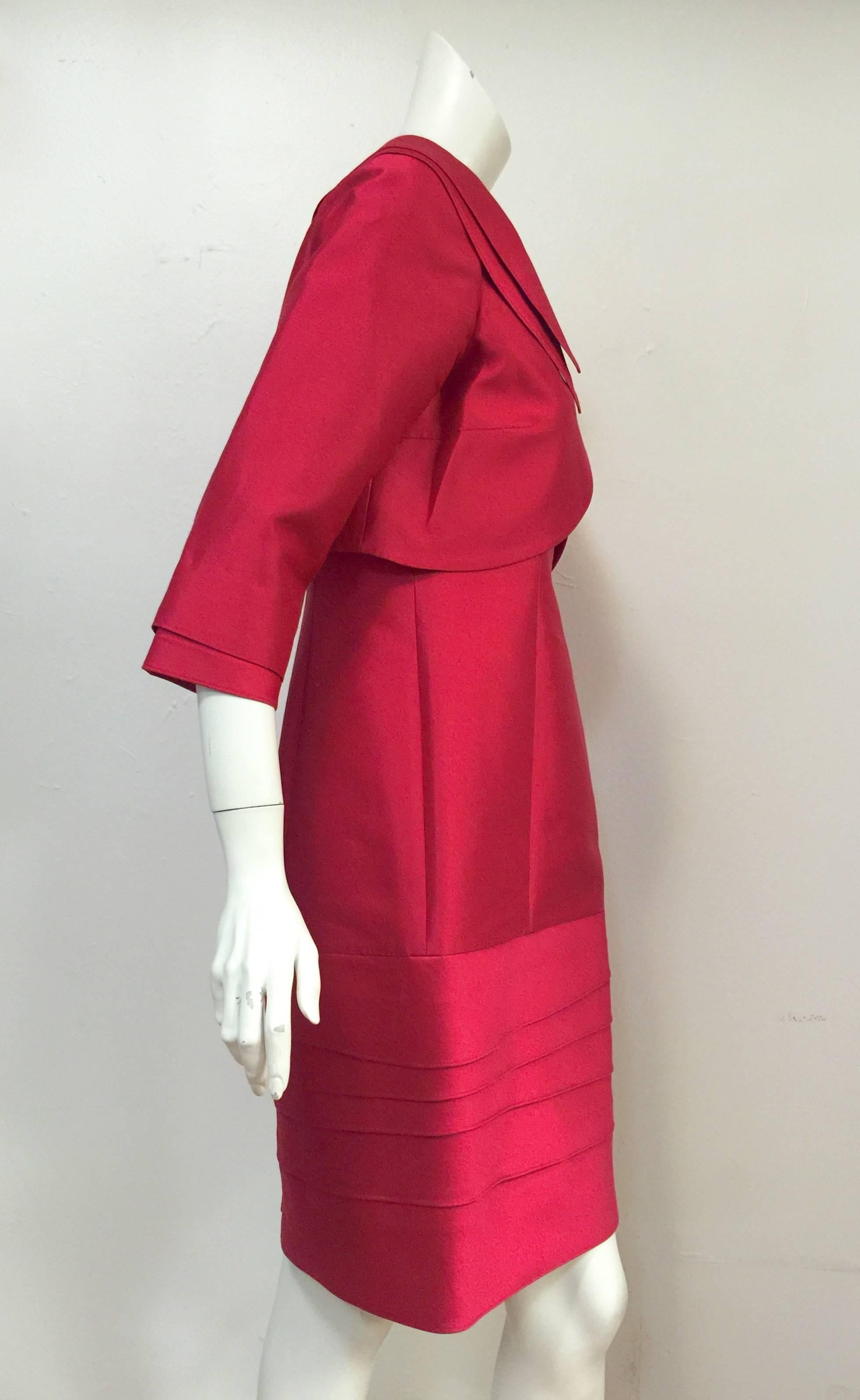 Teri Jon Shantung Jacketed Dress Ensemble is fit for a lady.  Fabulous fuschia fabric makes this confection unforgettable!  Features above the knee sleeveless sheath dress with bands of asymetric fabric from the lower body to hem.  Dress also has