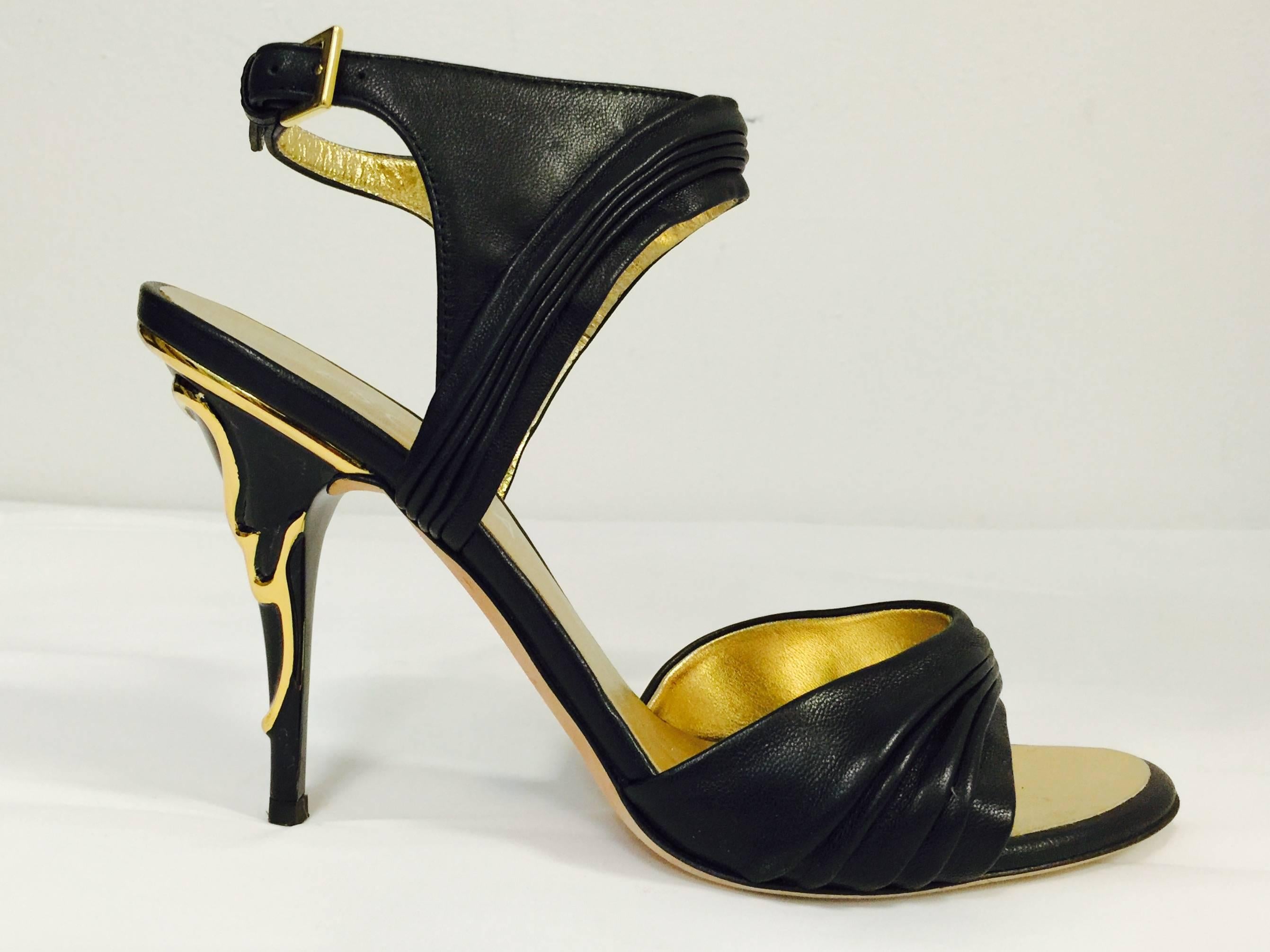 New Escada Evening Sandals promise an unforgettable entrance and exit!  Features butter soft black leather that has been gathered and pleated on the vamps and adjustable ankle straps.  Fully lined in metallic gold leather!  The showstopper?  Black