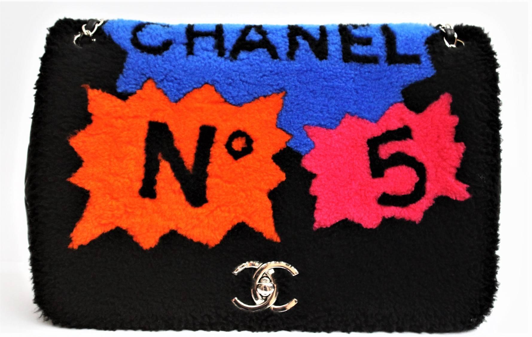This limited edition beauty from Chanel first made its debut in the 2014 Runway Collection and it features black and multicolor shearling with the famous Chanel No. 5 design on the flap, silver tone hardware CC lock and chain-link shoulder strap