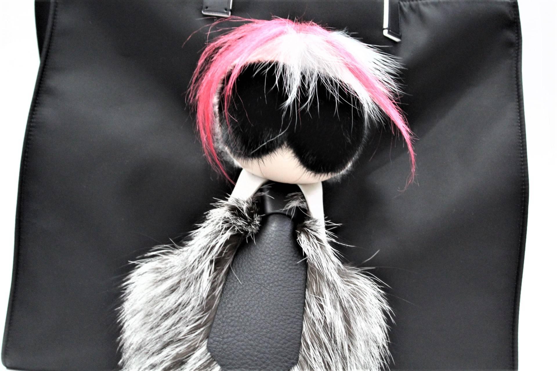 Only 600 items of this incredible bag are in the world. It’s a black textile tote with a giant Karlito mounted on the front, plus a pink fur mohawk down the back.