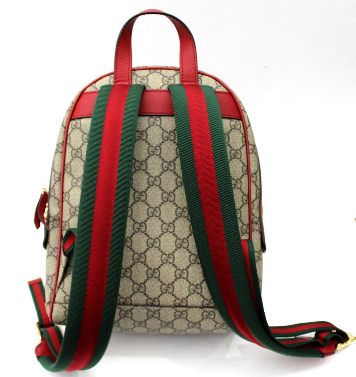 GG Supreme limited edition backpack with embroidered flower, snake and heart appliquésGG Supreme beige / ebony fabric Gucci Signature dark red leather with dark red leather trim.Applications flower, snake and embroidered heart.Front pocket with