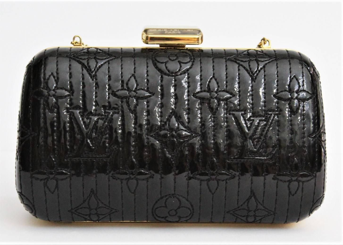 Look elegant with this Louis Vuitton Minaudiere Motard Clutch Bag. Great for an evening out or a fancy event, it can be worn over your shoulder or as a clutch with its chain strap tucked in. The exterior is a beautiful black vernis leather with