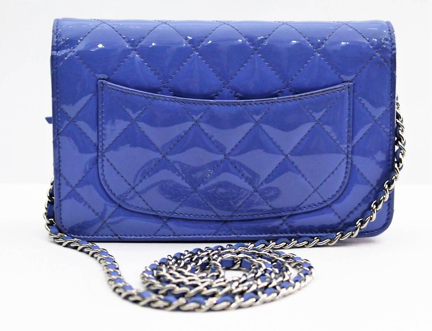 Gorgeous Chanel Lilac Quilted Patent Leather Wallet-on-Chain Clutch Bag. It features gorgeous quilted glossy, bright blue patent leather and a small silvertone CC logo on the front. The versatile leather strap chain can be worn cross-body, on the