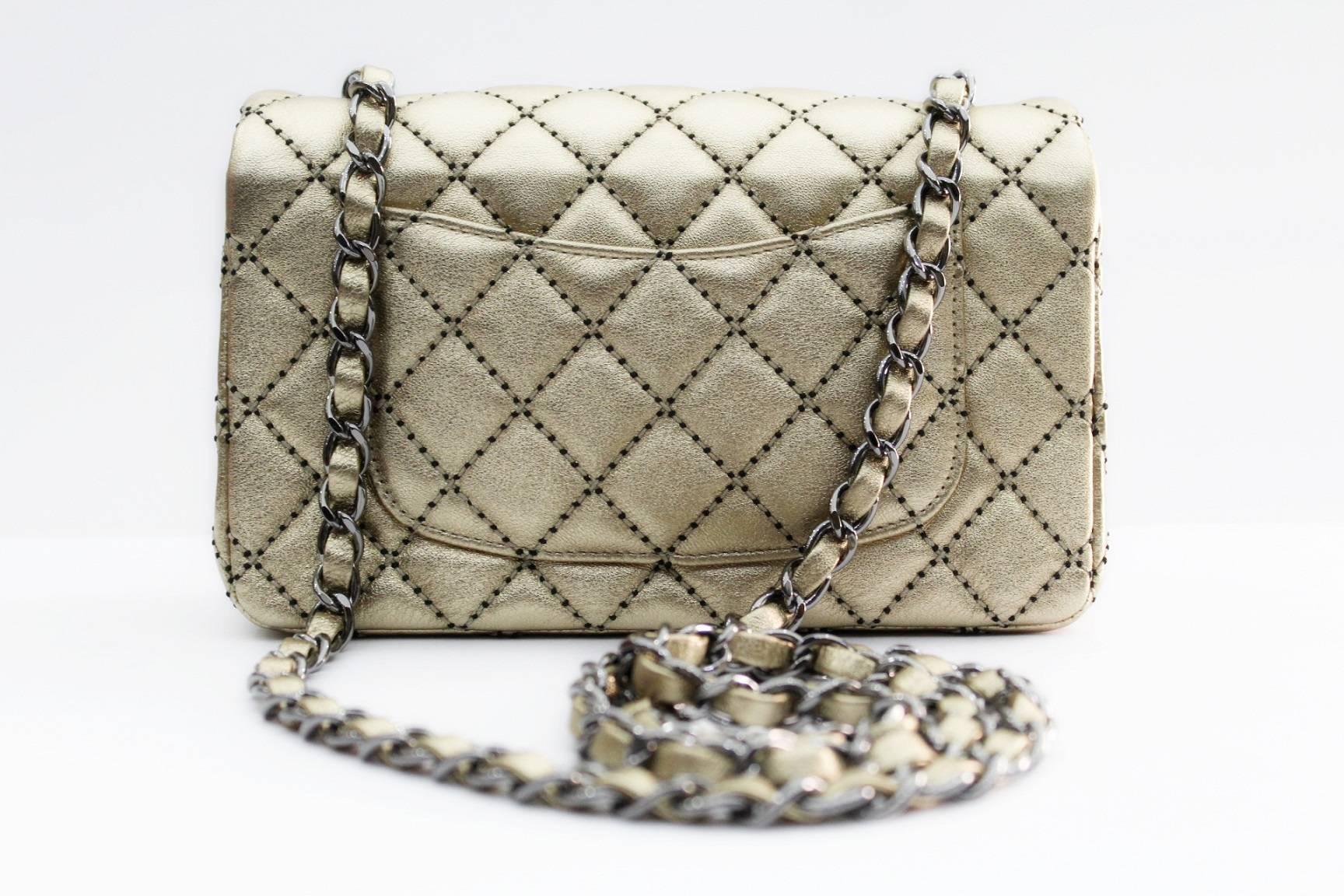 This adorable Chanel Gold/Black Quilted Lambskin Leather New Mini Flap Bag is in a mini size that amazingly holds your cell phone, keys, and lip gloss. It also features an inside flat pocket that fits cards or money as well as one zip pocket for