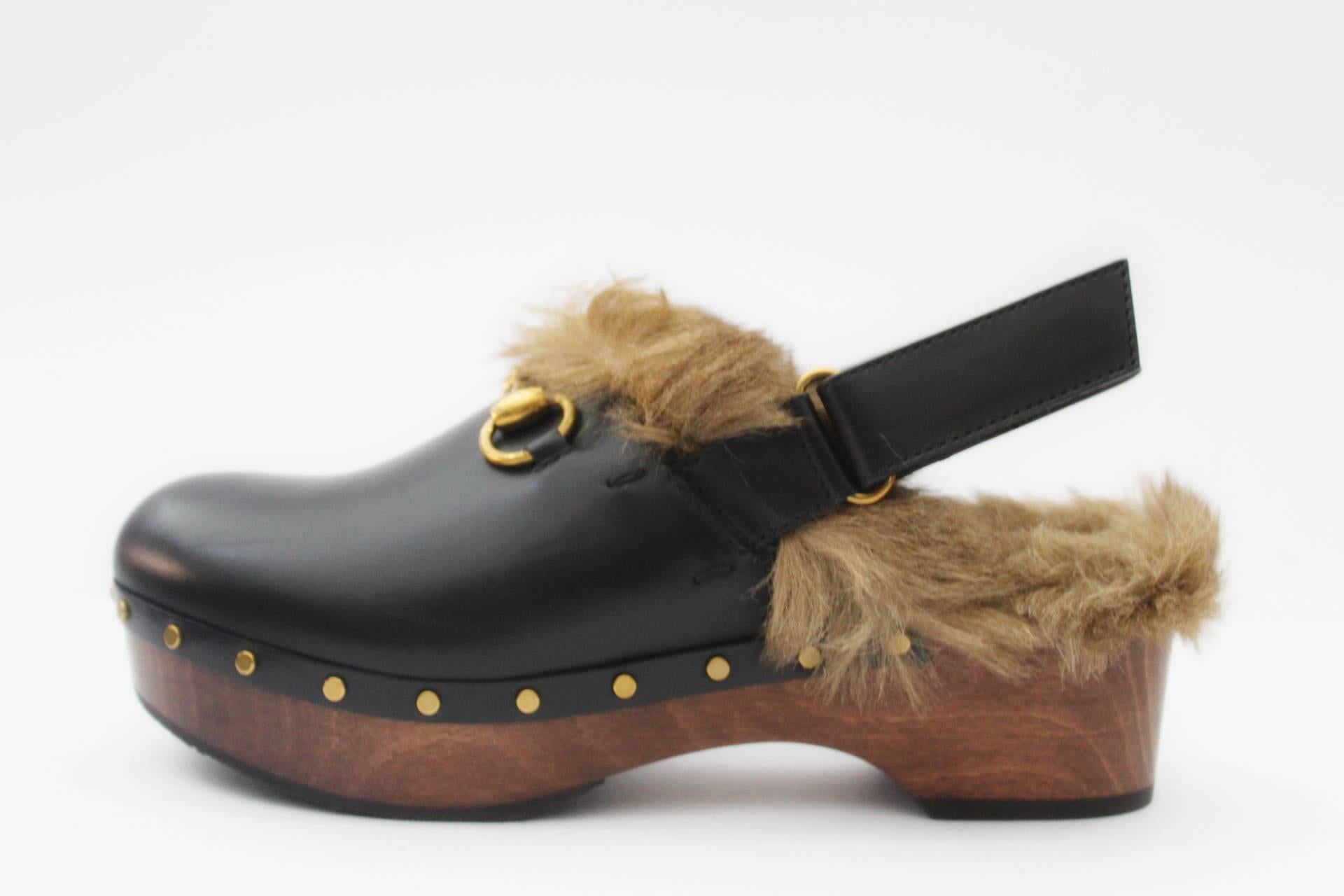 Fully lined and trimmed with kangaroo fur, this leather clog features gold studs and our signature Horsebit detail. Perfect conditions with dust and box. Number 38 EU