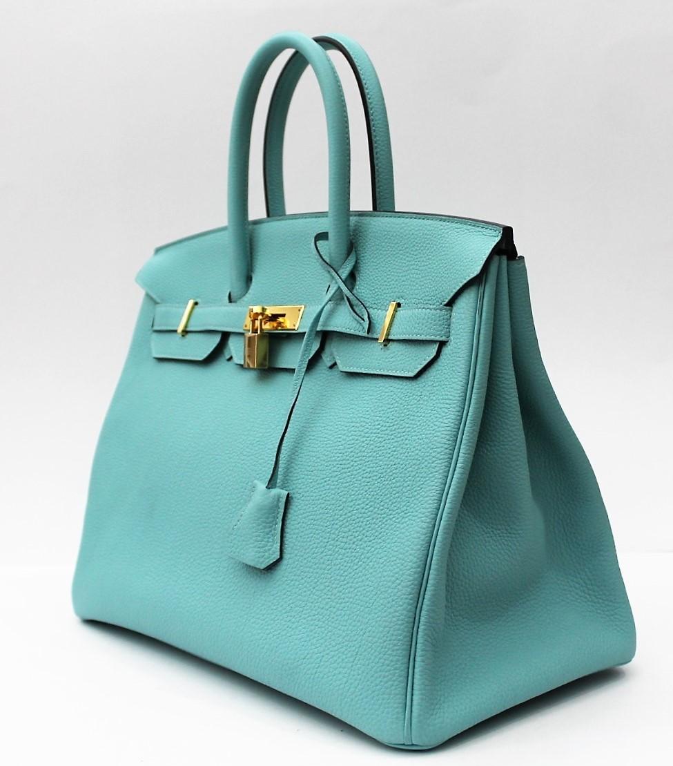 Hermes Blue Atoll 35cm of togo leather with gold hardware.
This Birkin has tonal stitching, a front toggle closure, a clochette with lock and two keys, and double rolled handles.
The interior is lined with Blue Atoll chevre and has one zip pocket,