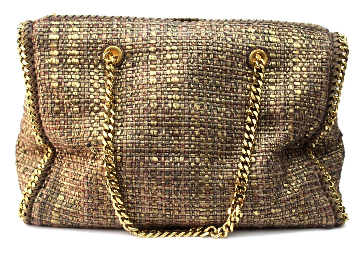 This particular Falabella is crafted out of a unique Boucle woven fabric with metallic threading.