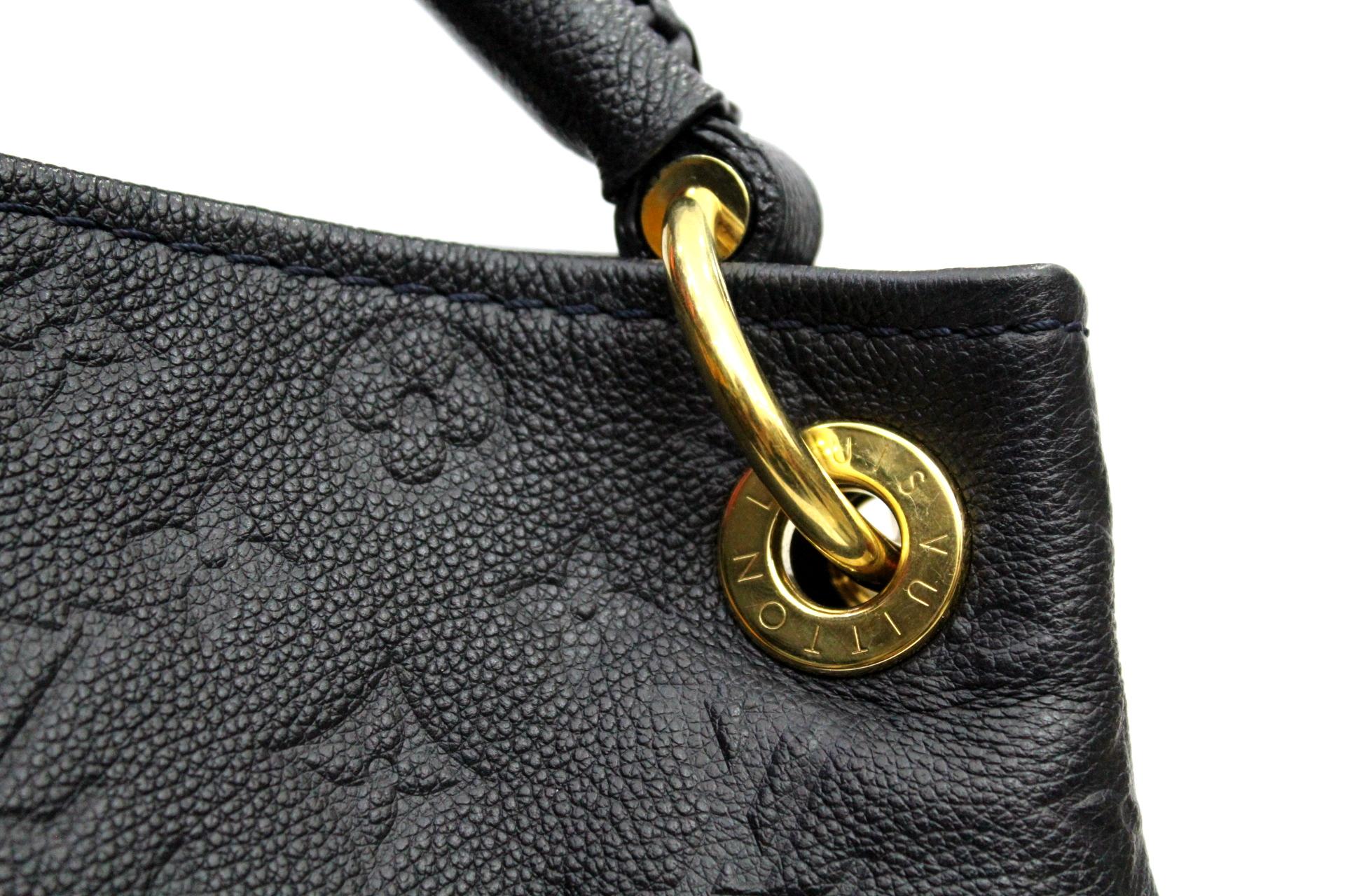 The Louis Vuitton Monogram Empreinte Leather Artsy MM Bag has a unique and modern structure. This roomy tote makes a perfect work or weekend bag, large enough to hold all your essentials in style. Made from the highest quality calfskin leather, this