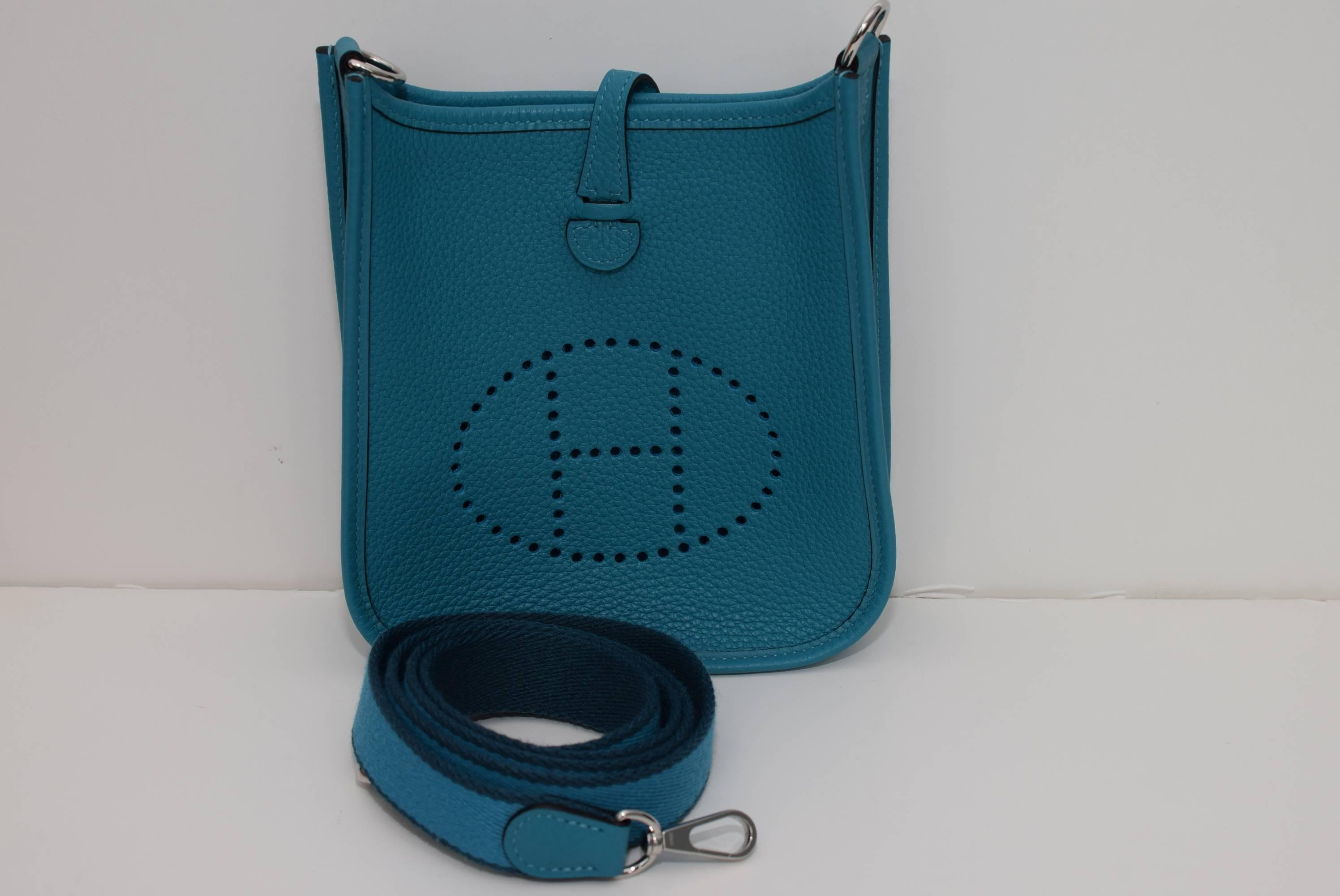 Like New - Hermes Mini Evelyn in Turquoise blue. Comes with box, dust bags and receipt.
Date code: R square Circa 2014. Excellent condition. Free priority shipping both ways. Perfect cross body bag fits all the essentials: phone, wallet, lipstick,