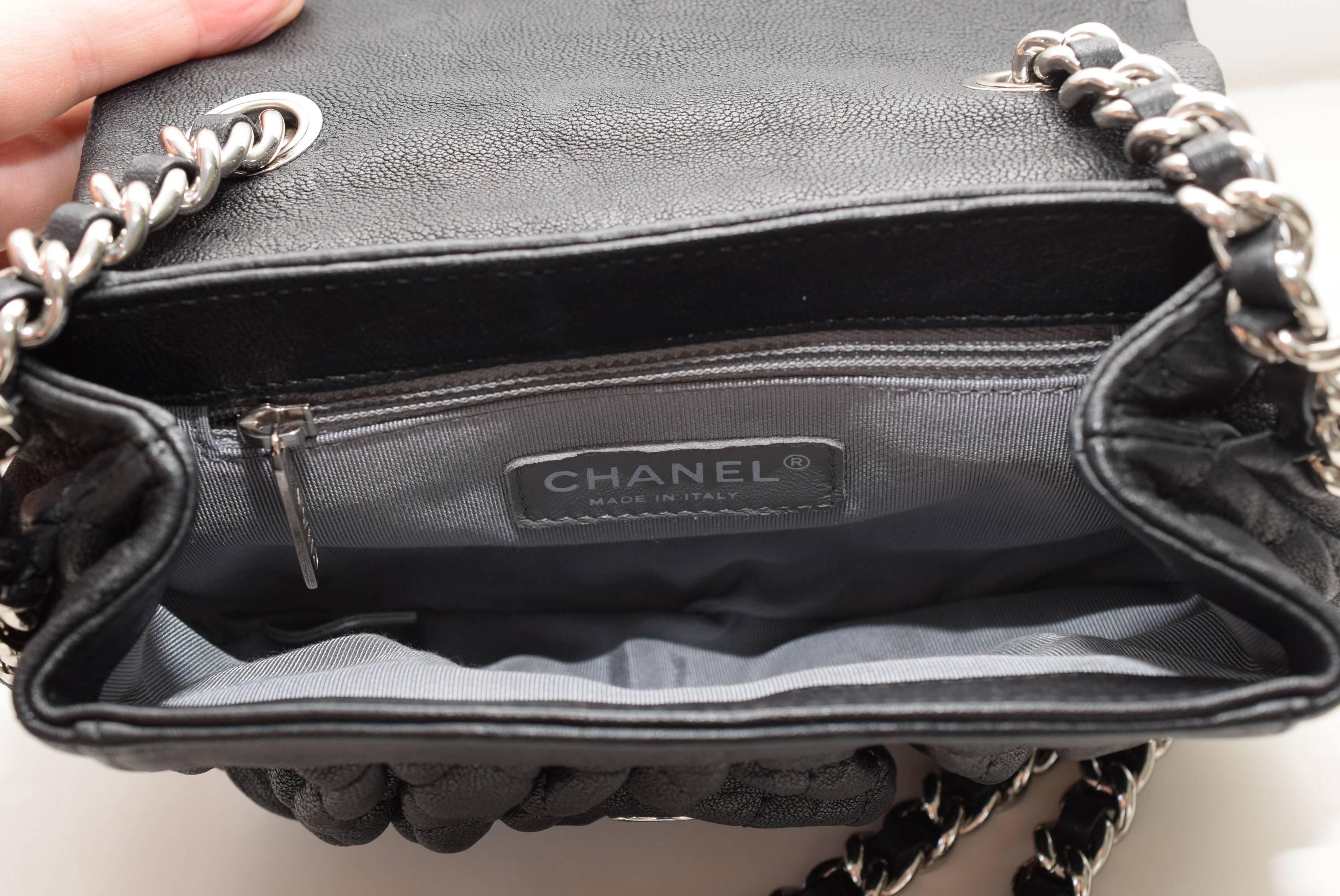 This is an authentic CHANEL Washed Lambskin Quilted small Chain Around Messenger in Black.  This chic cross body shoulder bag is crafted of luxuriously soft diamond quilted treated lambskin leather.  The bag features a chain link leather threaded