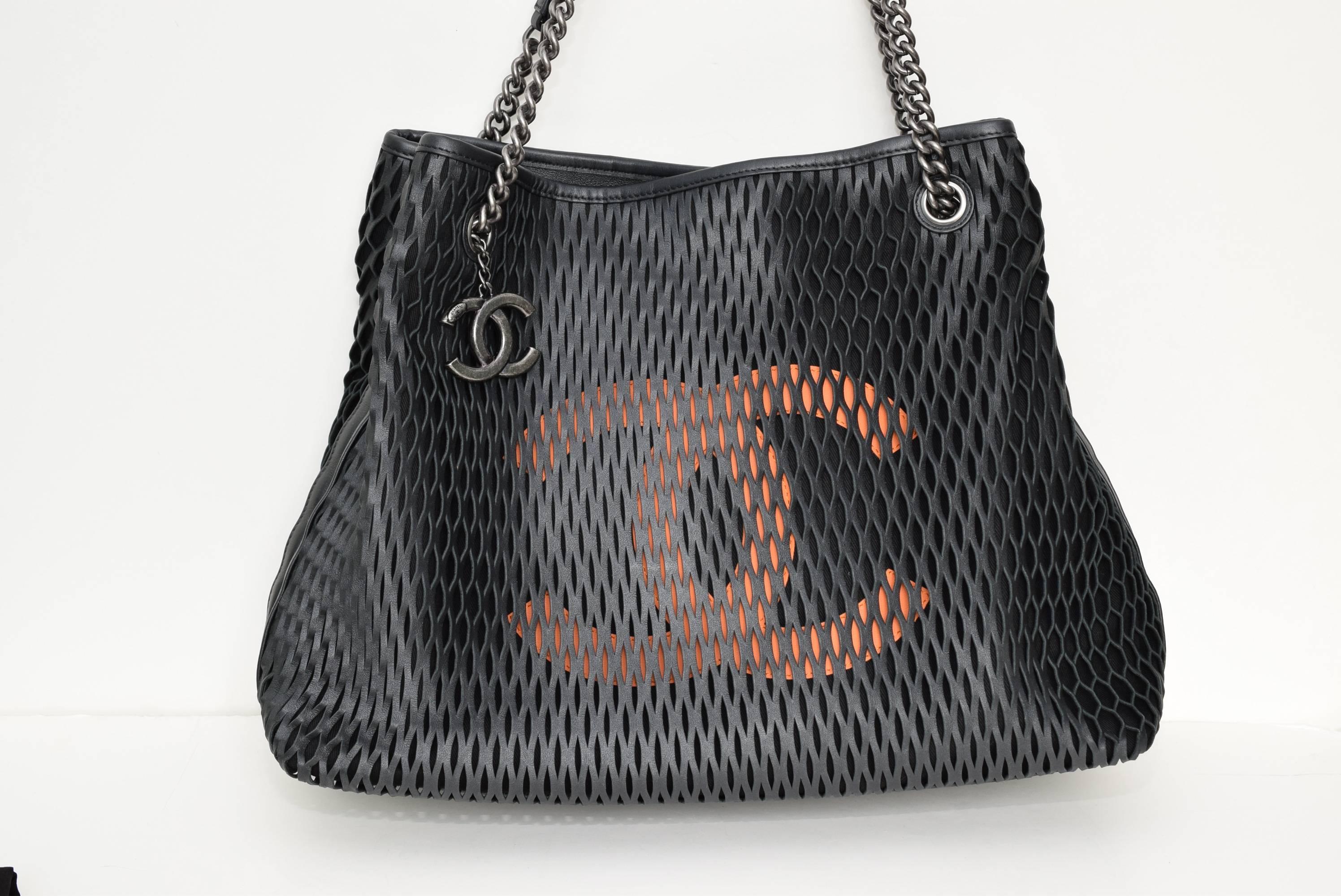 Brand New, never worn Chanel Black tote bag, embellished with a large orange CC logo on the front. Great CC signature Shopping Tote. 
Room for it all!
Comes with with dust bag and guarantee card and Chanel care card.
Free Shipping
Made in