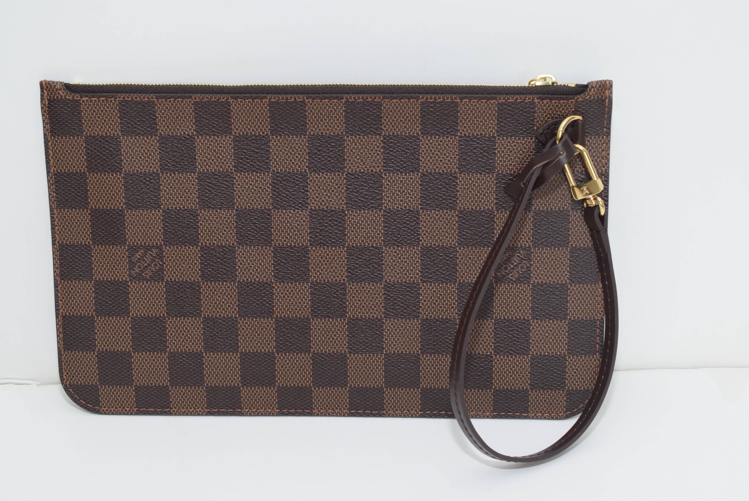 Brand new Louis Vuitton Neverfull Mm/ GM Pochette in Damier Ebene with cherry lining - date code AR4185. Made in France. Free priority shipping both ways.
 All of our bags are as stated. We ship within a day. Please check out our closet. We buy,