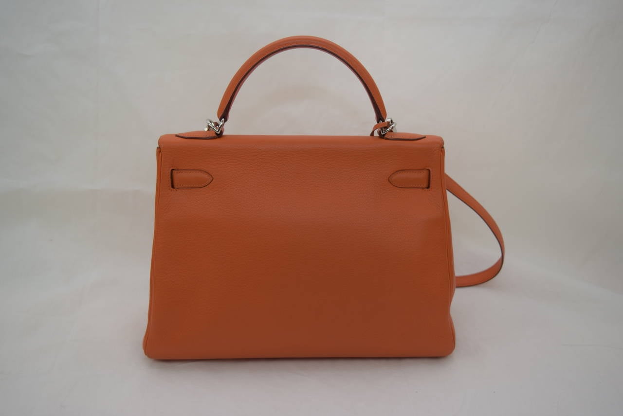 Hermes Kelly 32 cm Orange Clemence Bag with Palladium hardware .
Circa :2003 : G Square year with Shoulder Strap and Hermes Dust Bag .
Very Good Condition .No Scruff Marks on the surface of the bag .
Dimensions :12 1/2 x 5 x 9 .Shoulder drop 17