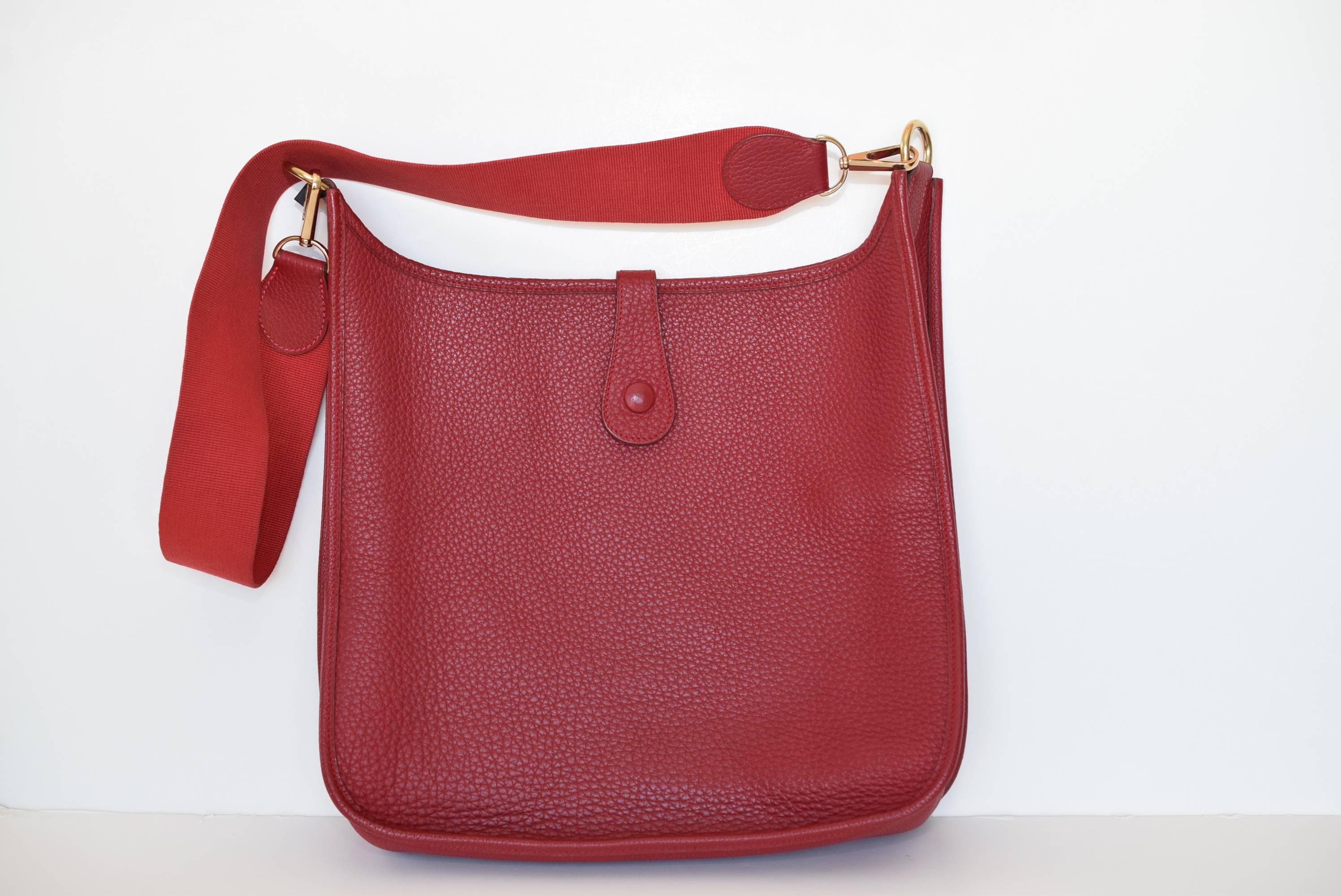 Red Clemence leather Hermes Evelyn l GM with goldstone hardware, perforated logo at front, red suede interior lining and snap closure at back.  
Excellent condition.

Free Shipping 