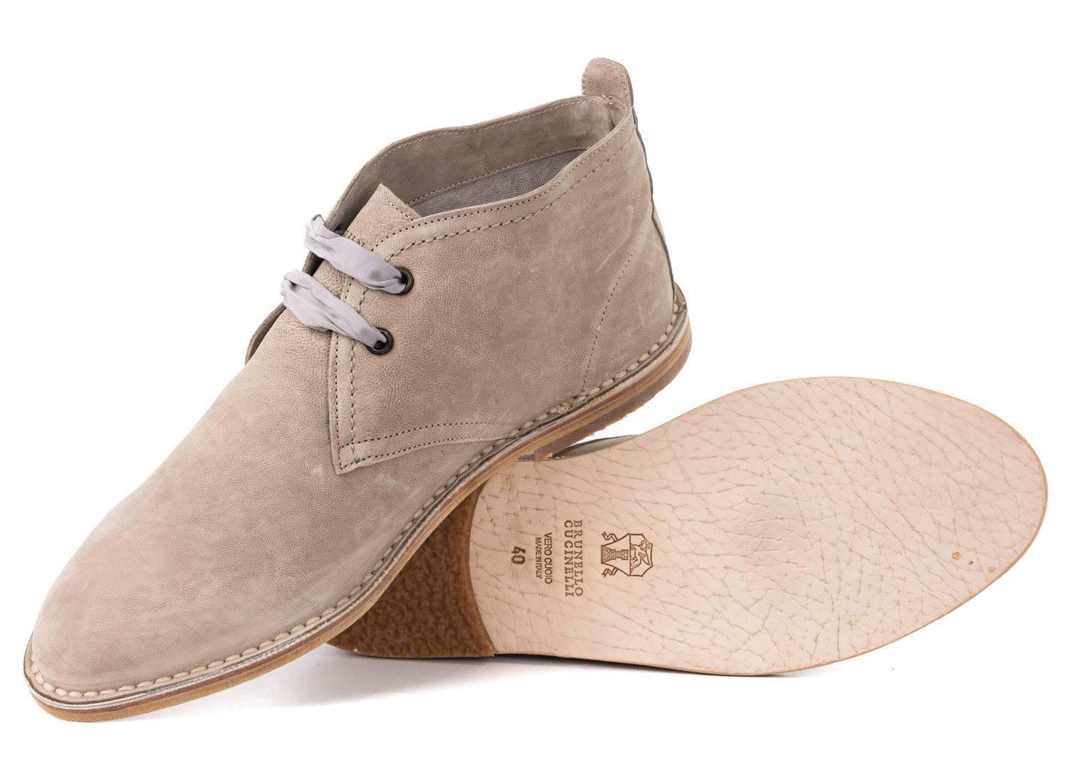 Lace up your Brunello Cucinelli Desert Boots and master the days trail. These fine boots feature beige richly grained leather, grey tricot lacing, and tonal stitched wooden sole. You can pair this shoe with an tonal ensemble and weather any