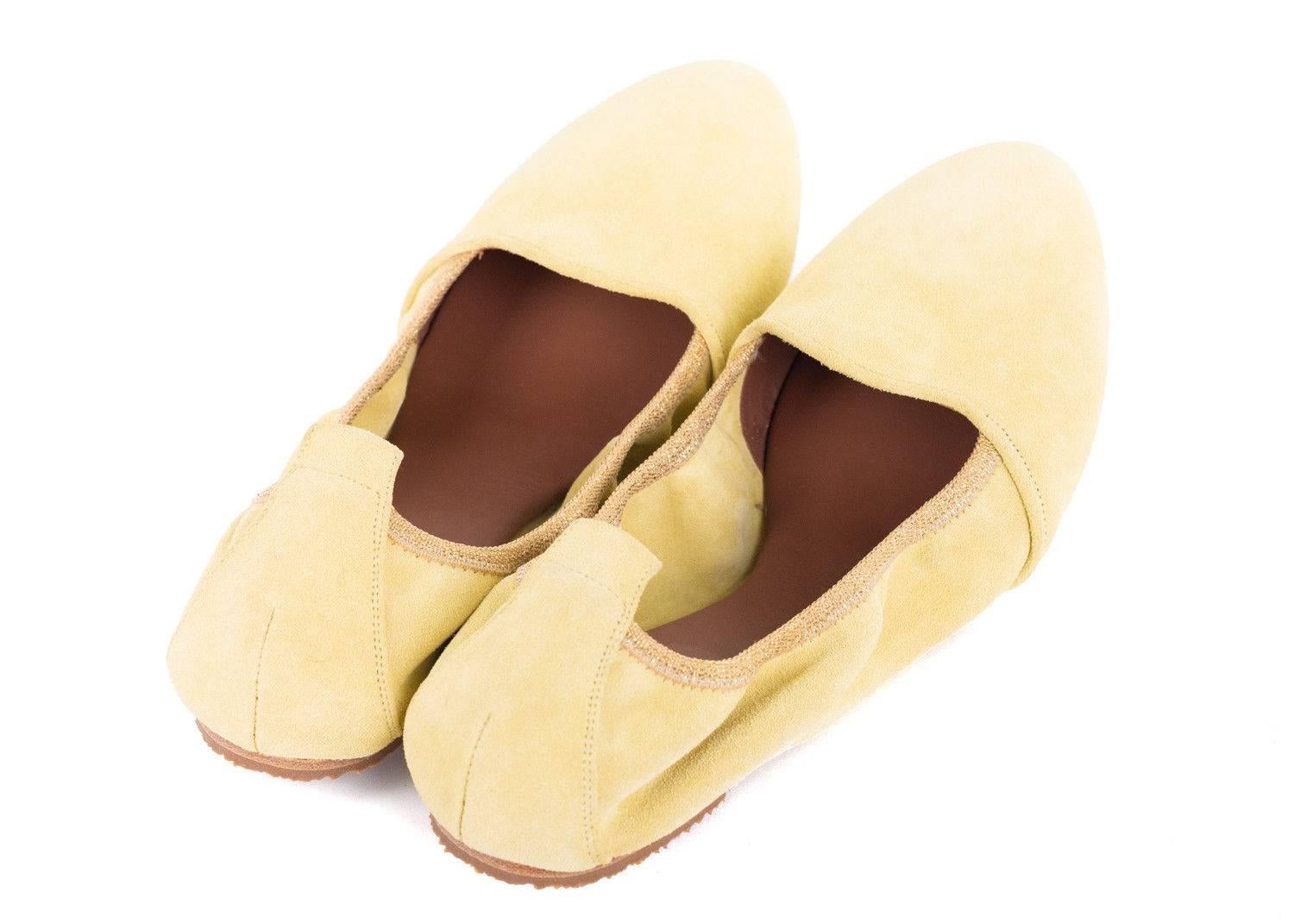 runello Cucinelli's pale yellow ballet flats are every woman's spicy essential. These flats feature a richly smooth suede panel, gold lurex trimmed elastic band, and tonal heel cap. You can pair these shoes with any dress, pants, or two piece