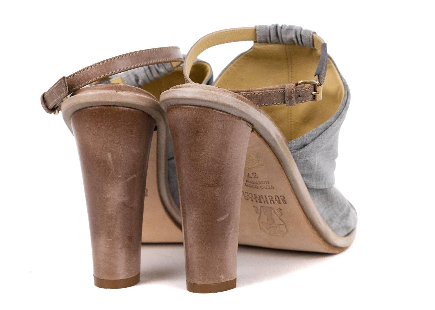 Inject summertime fierce into your ensemble with Brunello Cucinelli mules. These heels feature a grey ruched fabric, generous peep toe front, and a 4 inch block heel. You can par this shoe wit that aerated grey summer dress for the perfect
