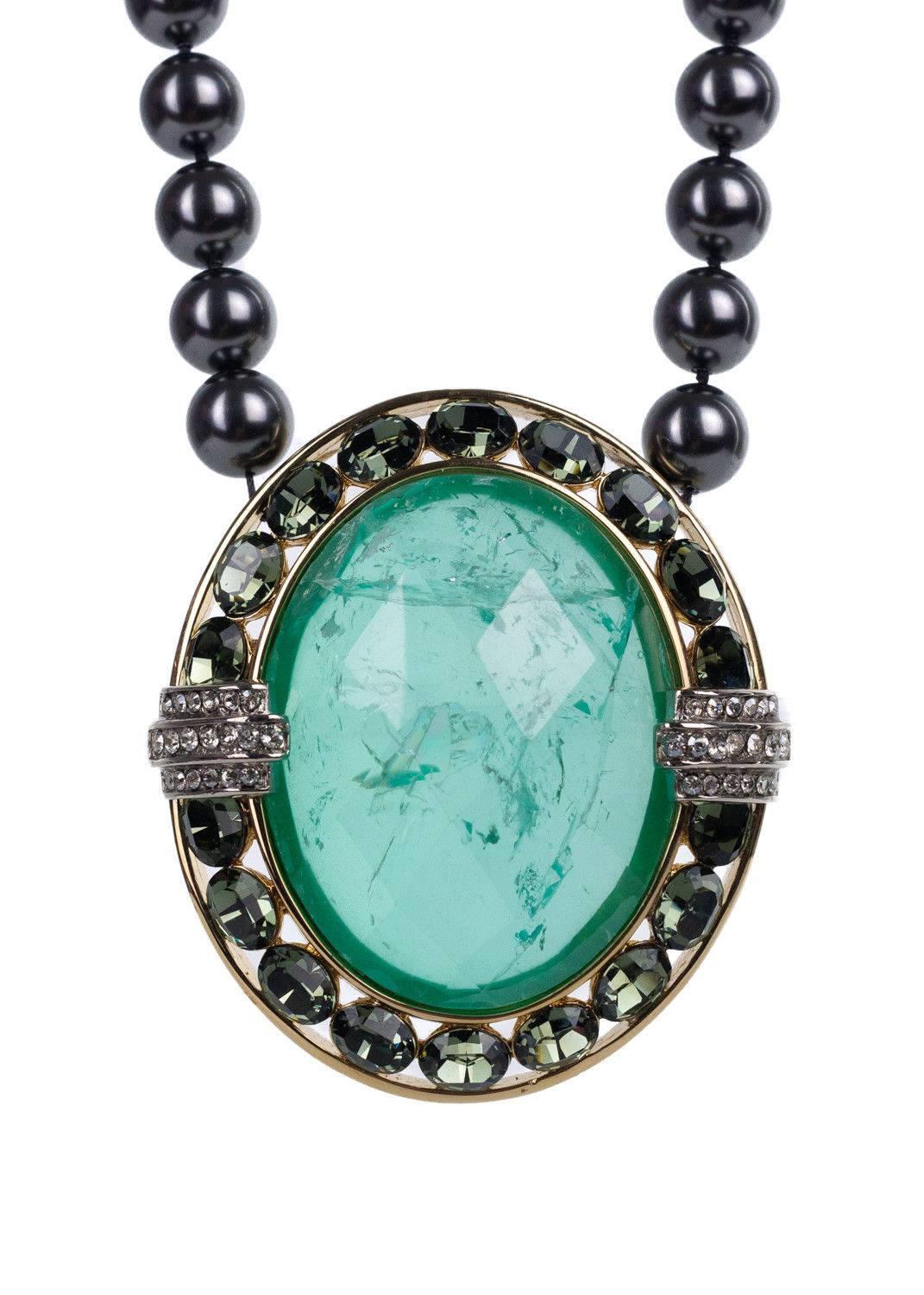 Roberto Cavalli's Sea Green Pendant Necklace is the perfect accessory for the evening. This chiseled sea green stone features analogous embellished stones, a gunmetal tone pearl necklace, and tonal lobster clasp closure. You can make your entrance