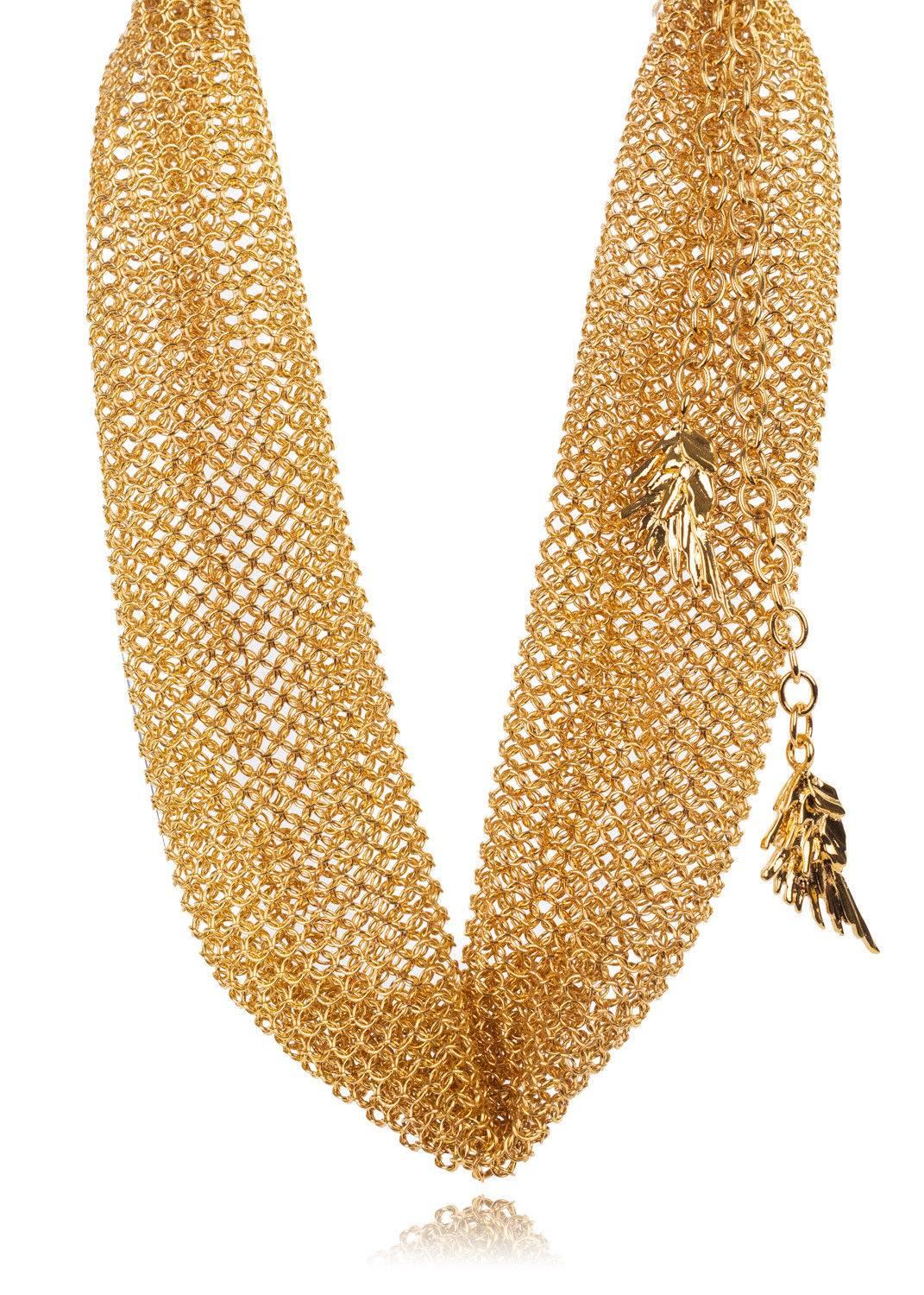 Top off your ensemble with Roberto Cavalli's Gold Chainmail Choker. This lightweight accessory features the nostalgic chainmail metal, feather charm accented clasp, and three ring adjustability. You can pair this choker with a deep plunge neckline