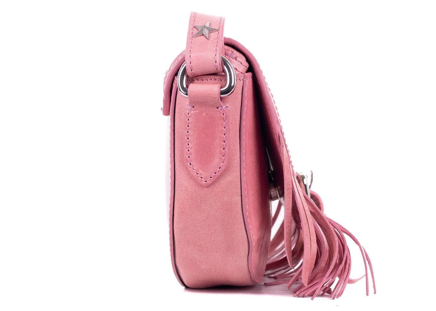 Roberto Cavalli pink leather shoulder bag. This shoulder bag features star hole detailing with fringes on the bottom and silver tone hardware. This bag is great for the incoming spring summer season. Pair it with all white shorts and a floral top