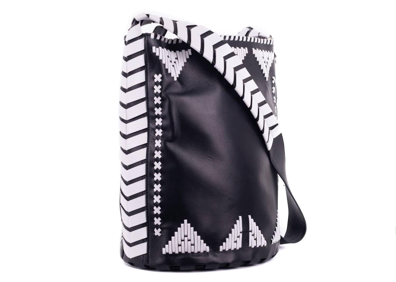 Revamp your accessories closet with this uniquely crafted shoulder bucket bag by Roberto Cavalli. This black color bag features white woven leather and elephant hardware along the shoulderline. Simply pair it with absolutely any outfit for a chic