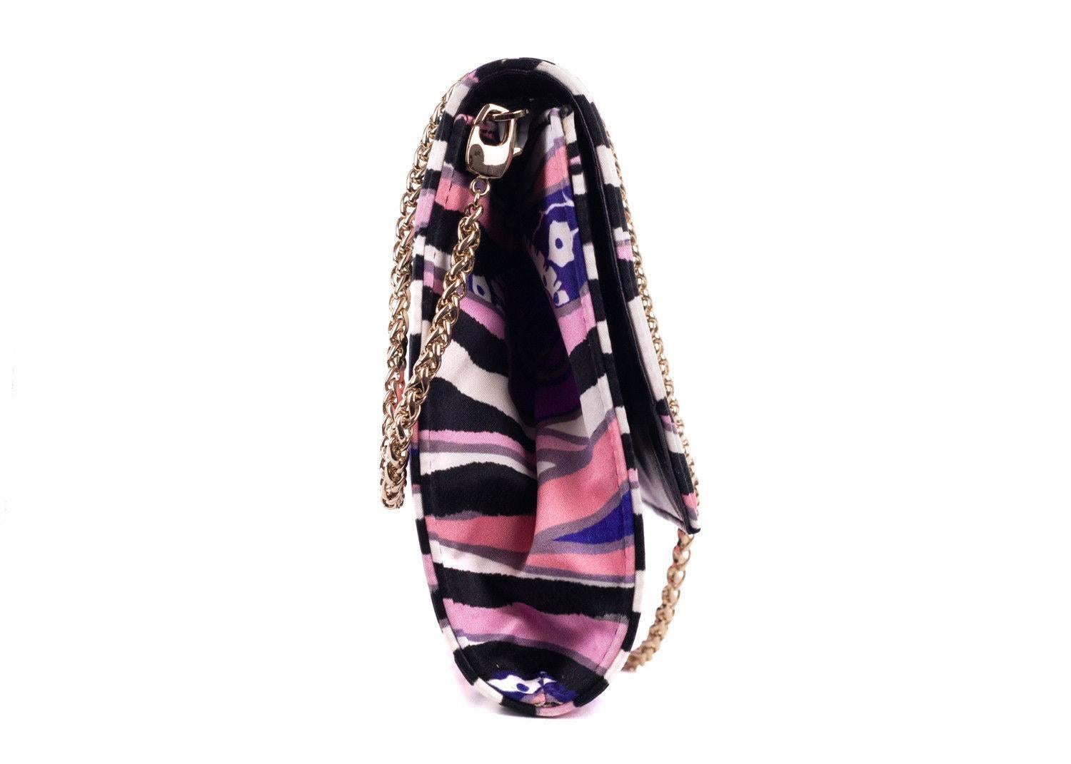 Roberto Cavalli multicolor pink purple clutch. This clutch can also be worn as a shoulder bag with its detachable gold chain shoulder strap. Perfect for the incoming spring summer season, pair it with denim and a cute solid blouse for a chic laid