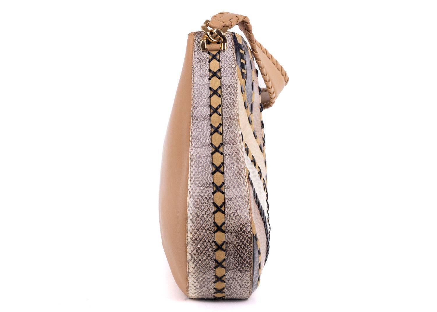 Roberto Cavalli tote shoulder bag in a light tan brown color. This bag features a black wiven detailing with snake embossed print throughout. This large tote is perfect to store all your everyday essentails in safely with its zip closure. Pair it