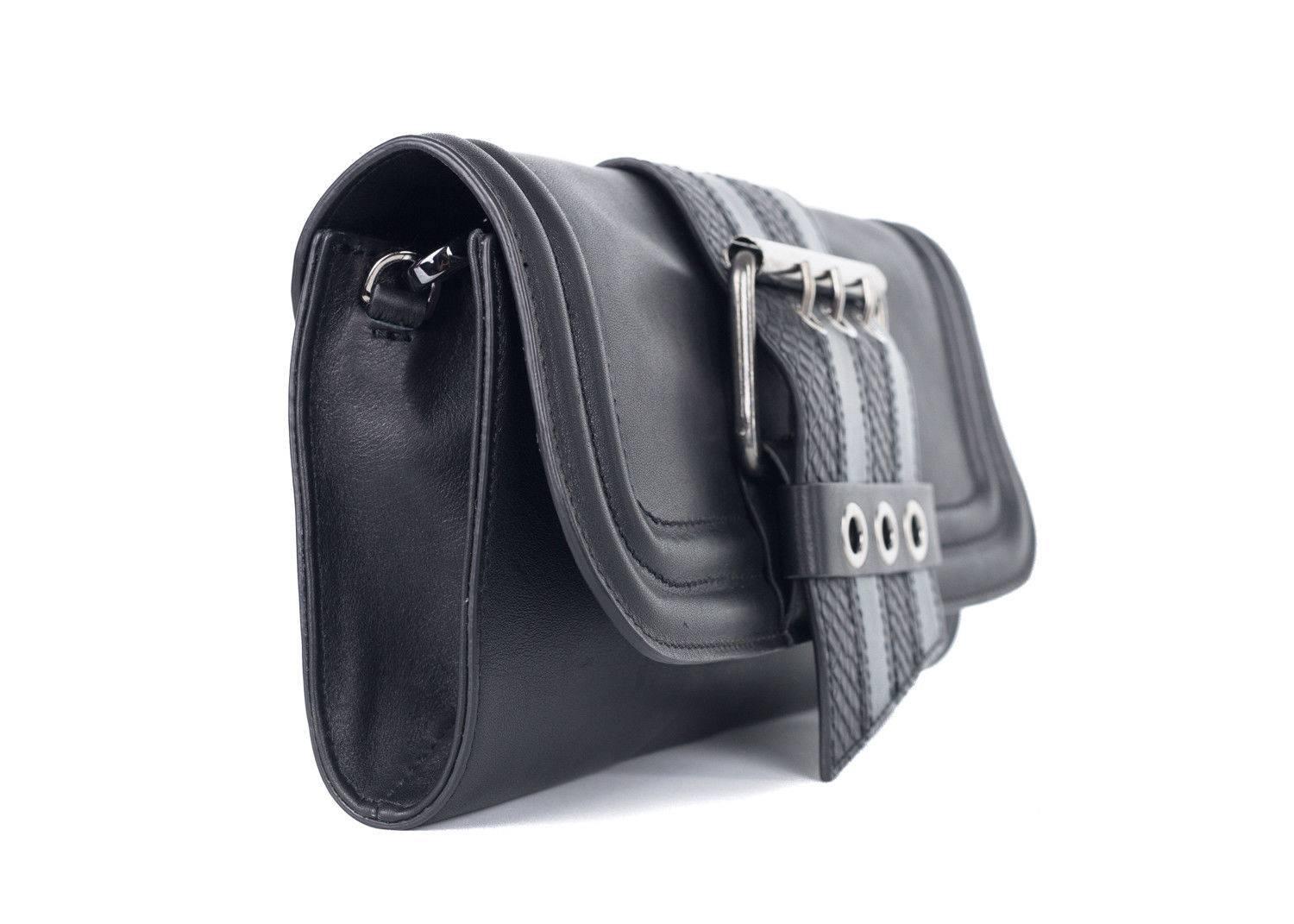 Just Cavalli black leather clutch shoulder bag. This bag features a metallic strap with accents of snake embossed print and matching silver tone hardware. Give your style a slight edge with this black clutch shoulder bag or use it as an everyday bag
