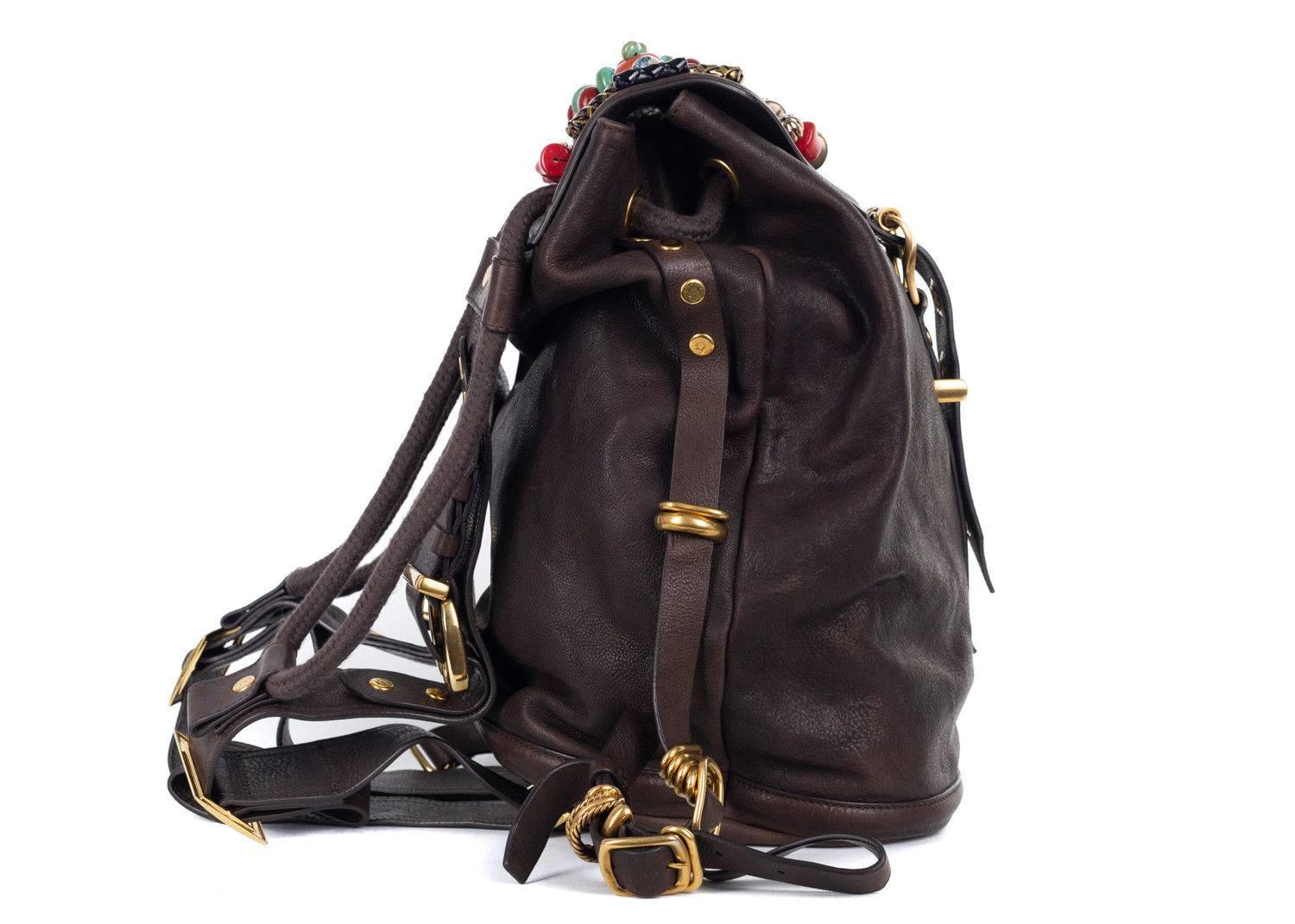 Just Cavalli brown calfskin leather backpack. This leather backpack features metal and marble appliques with matching shiny gold tone hardware. Perfect to store your essentials, this bag has a large space for storage and is safelt fastened with a