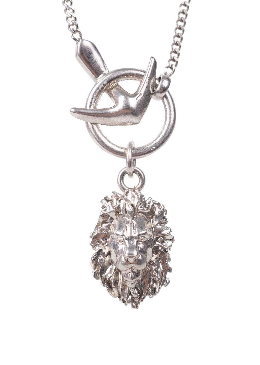 Get your Roberto Cavalli Necklace for the ultimate win. This necklace features a thin silver chain, small lion head pendant, and tonal silver circular appliques. You can pair this necklace with a deep v neck dress and go. 

11 inch Length
1 inch