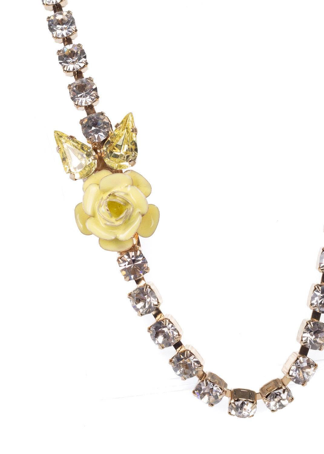Start your spring off right with your Roberto Cavalli Stone Necklace. This necklace features a yellow enameled floral jeweled applique, light gold tone base, and chiseled swarovski crystals. You can pair this necklace with a yellow shift dress and