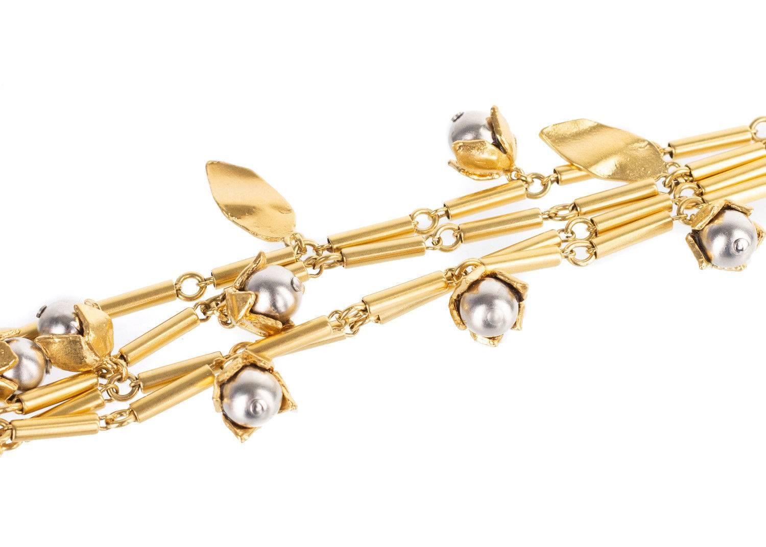 Start your spring off right with your Roberto Cavalli Bracelet. This rare piece features metal carved leaves, silver encased gold toned buds, and bar linked chains. You can slip this bracelet on with a shift dress and gold heels for the perfect