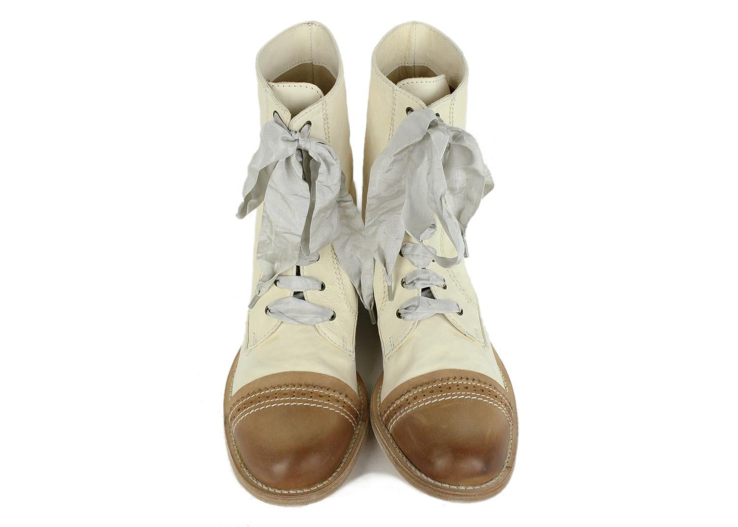 Brunello Cucinelli Ivory Brown Leather Lace Up Boots. The color contrast of ivory and brown tones give these boots personality and are nostalgic from another time. Wear these with a short floral dress for a cute 90's inspired look.

Leather
Lace Up