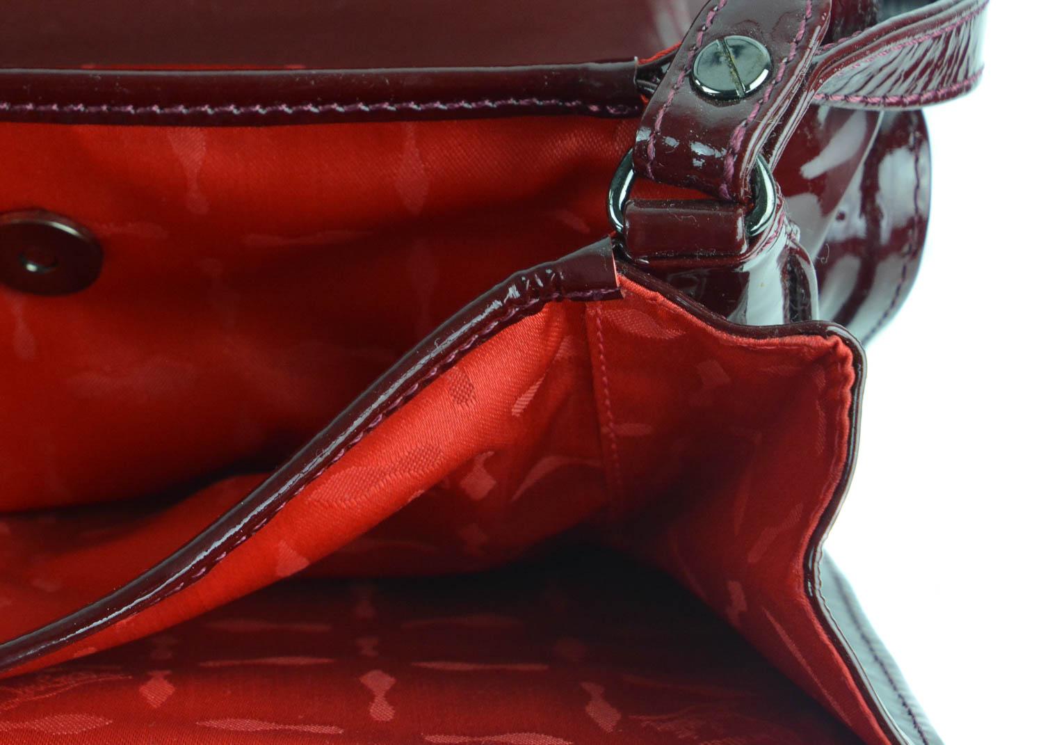 Christian Louboutin burgundy patent leather shoulder bag. This bag features an allover solid color on a patent leather textile. The bag is a great everyday bag to wear throughout all seasons with its color. Pair with denim and a blouse for a laid