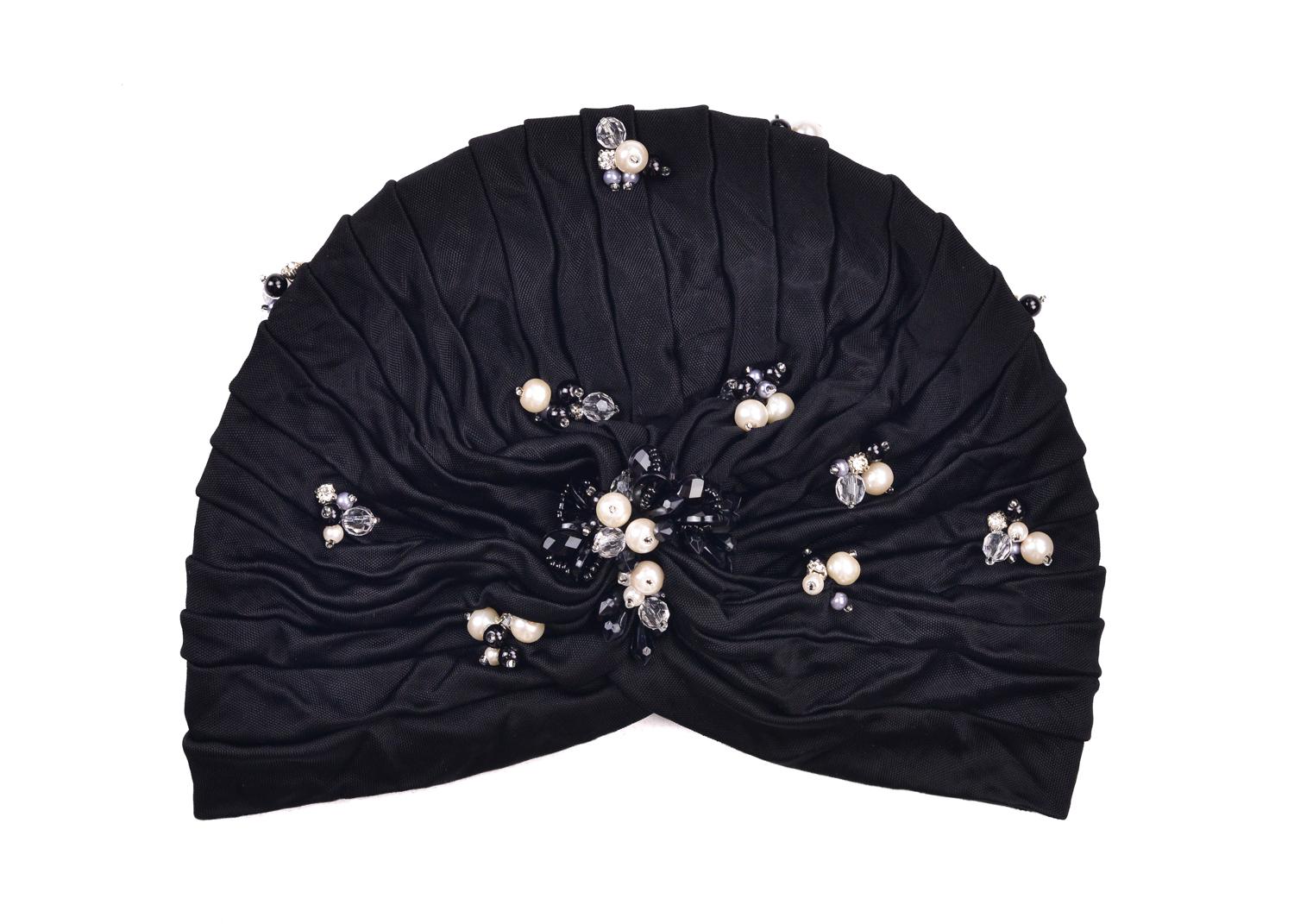 Be one with artistic rarity with Roberto Cavalli's Soft Pearled Turban. This head piece features sleek pearls, chiseled transparent stones, and grey and black micro pearl appliques across a tiered body. You can wear this evening classic before or