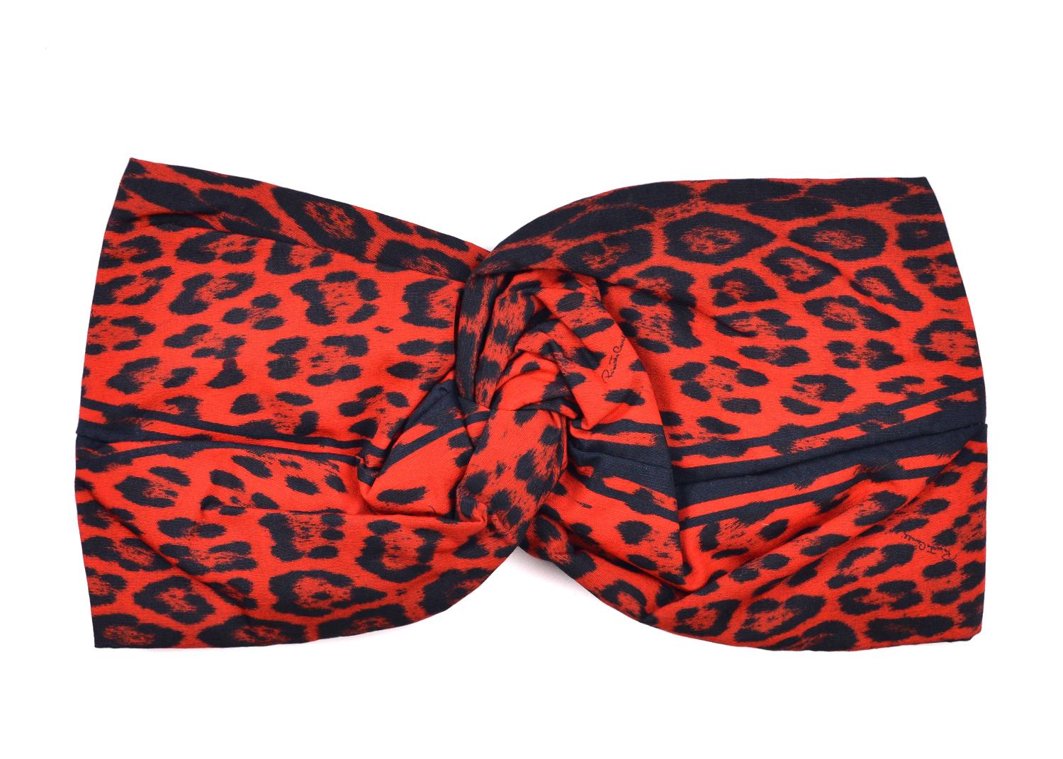 Be one with your wild artisan side with Roberto Cavalli's Cheetah Print Hair Band. This well kept vibrant piece features a ruched centered leather ring, racy black and red cheetah print, and high quality cotton design for aeration and comfort. Dawn