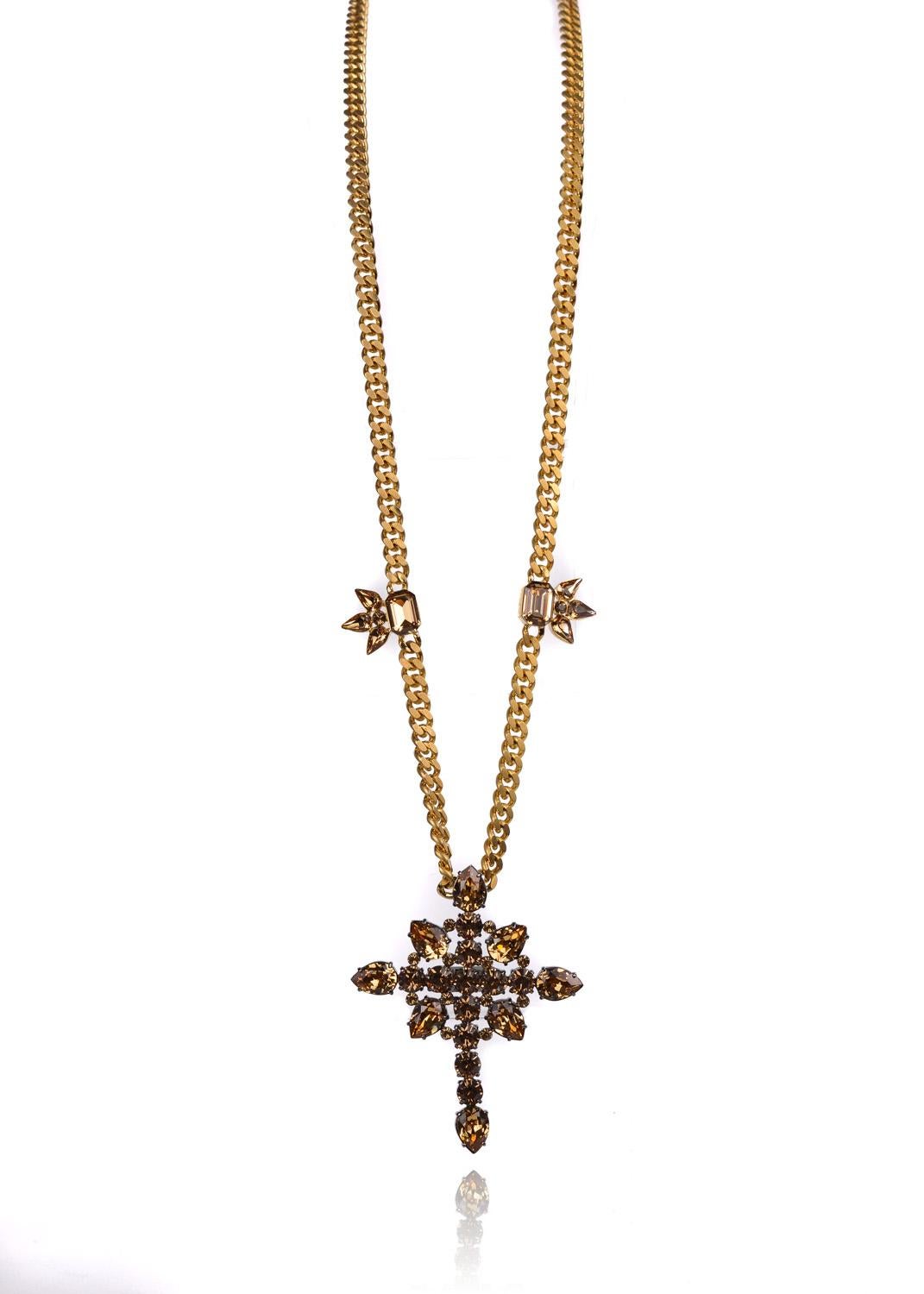 Treat yourself to Roberto Cavalli's divine creation with this Cuban Curb Cross Necklace. Roberto Cavalli's highly skilled artistry features durable gold cuban curb links, brown tinted glacial reminiscint Swarovski Crystals, and Swarovski secured