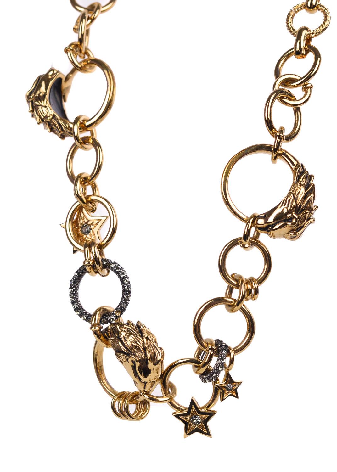 Exceed all artistic standards when in your Gold Roberto Cavalli Choker. This necklace features the classic Belcher chain link, gold lion head rings, and grey swarovski crystal embedded star ringed charms. You can pair this choker with that sheer