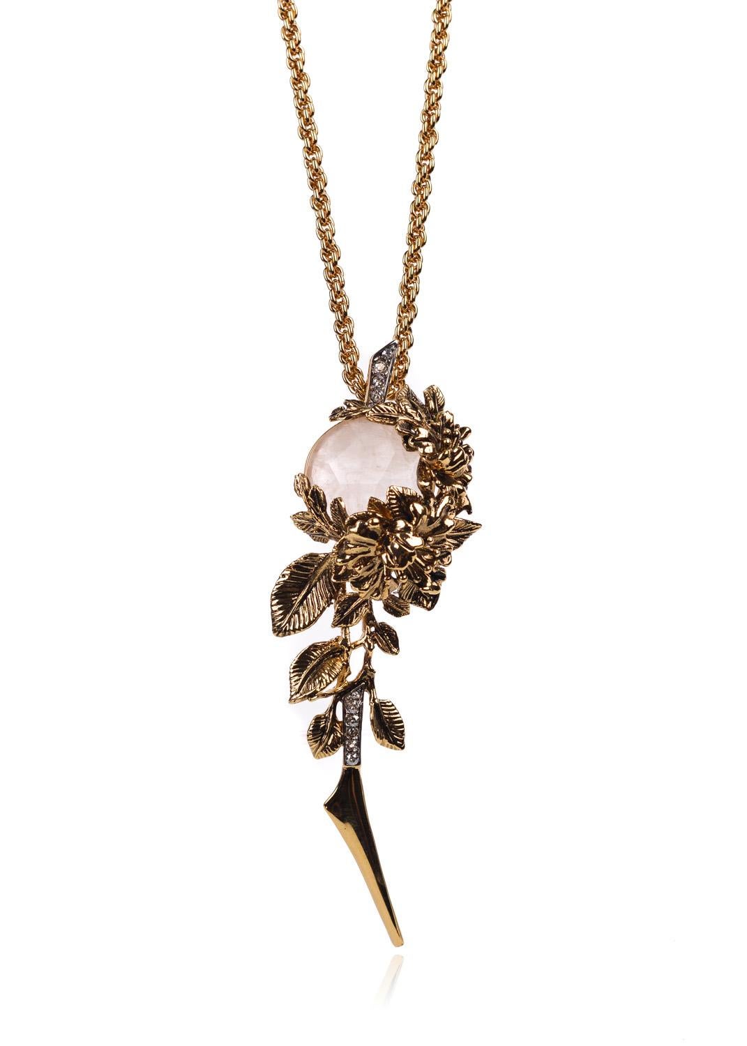 Explore your wild side with Roberto Cavalli's Swarovski Floral Pendant Necklace. This elegant piece features a chiseled white opal Swarovski Crystal, gold engraved floral encasing, and a striking Swarovski tipped leaf. You can pair this necklace