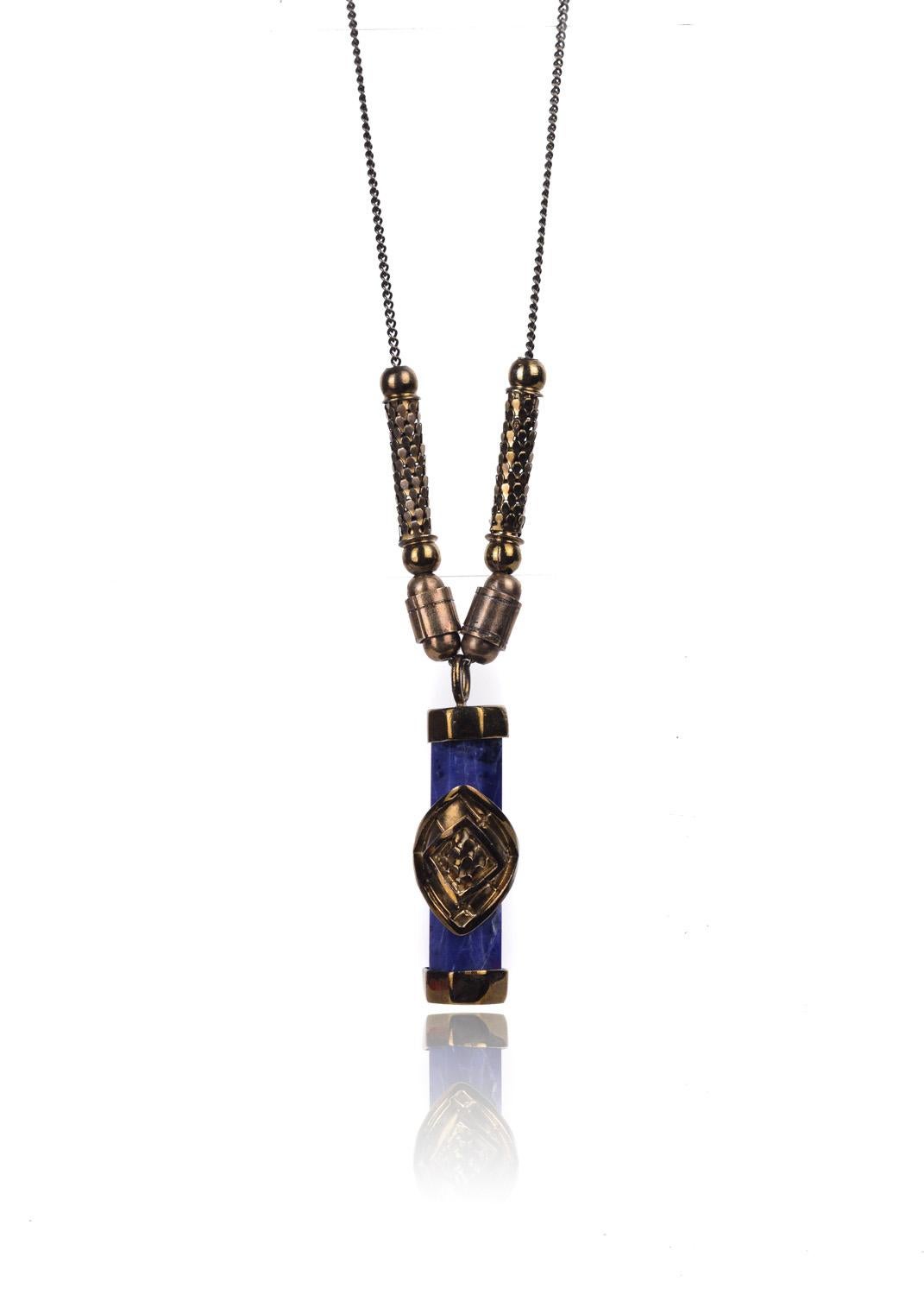 Add Artistic depth to you ensemble with Roberto Cavalli's Blue Marble Prism Necklace. This geometric piece features a brass octagon prism, centered beveled brass applique, and flexible scaled brass chain sliders. You can slip this necklace on with a