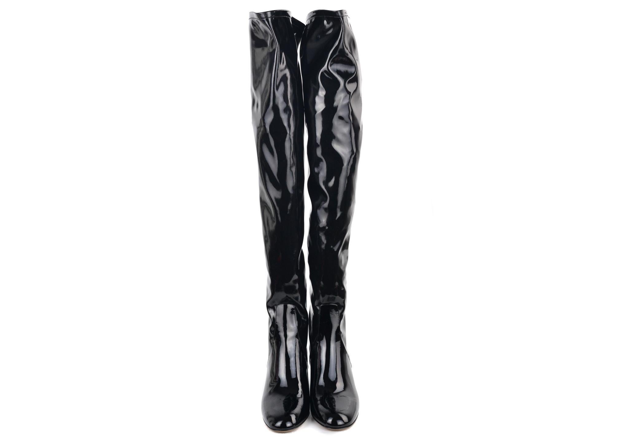 Solidify the final statement in your Valentino Thigh High Boots. This heeled boots feature rich high shine patent leather, a 2.5 inch chunky heel, and a tonal back zipper. You can pair these heels with a tonal bodycon dress for the ultimate